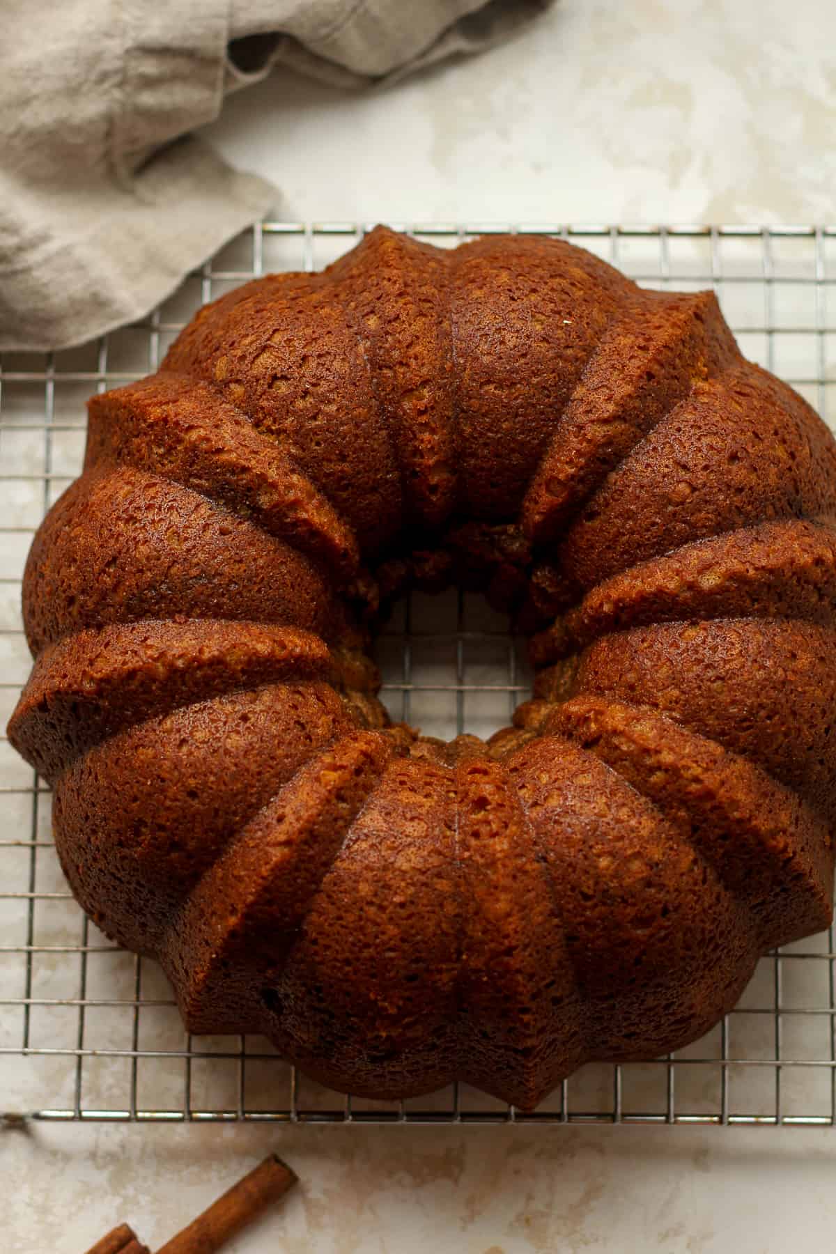 Overhead view of a just baked pumpkin bundt cake on a wire rack.