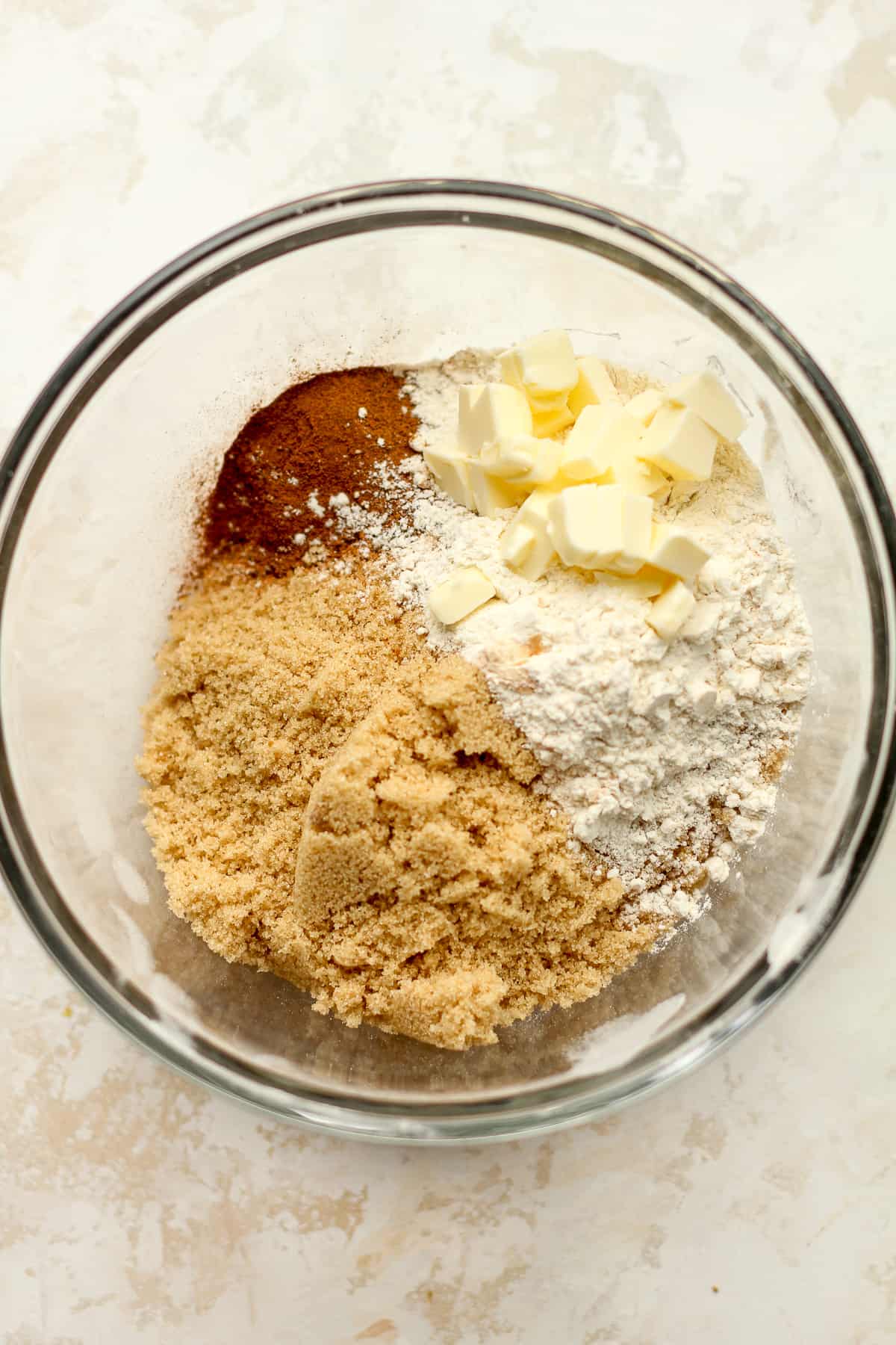 A bow of the streusel ingredients in a bowl before mixing together.