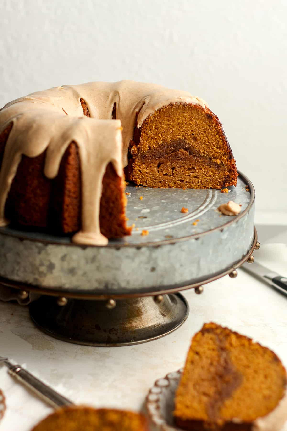 Side view of a pumpkin bundt cake with streusel in the middle.