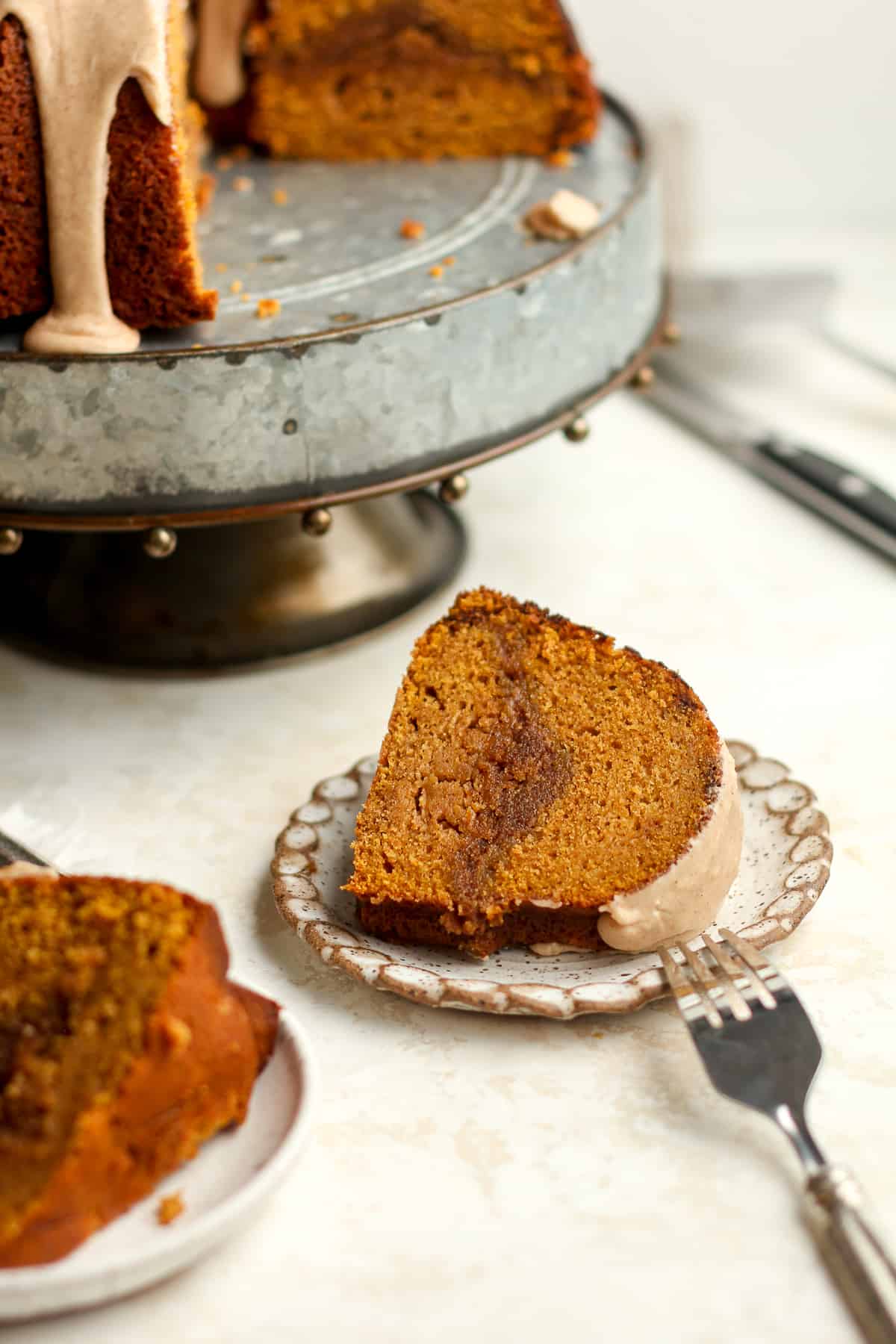 Side view of slices of pumpkin bundt cake with the cake tray in the background.