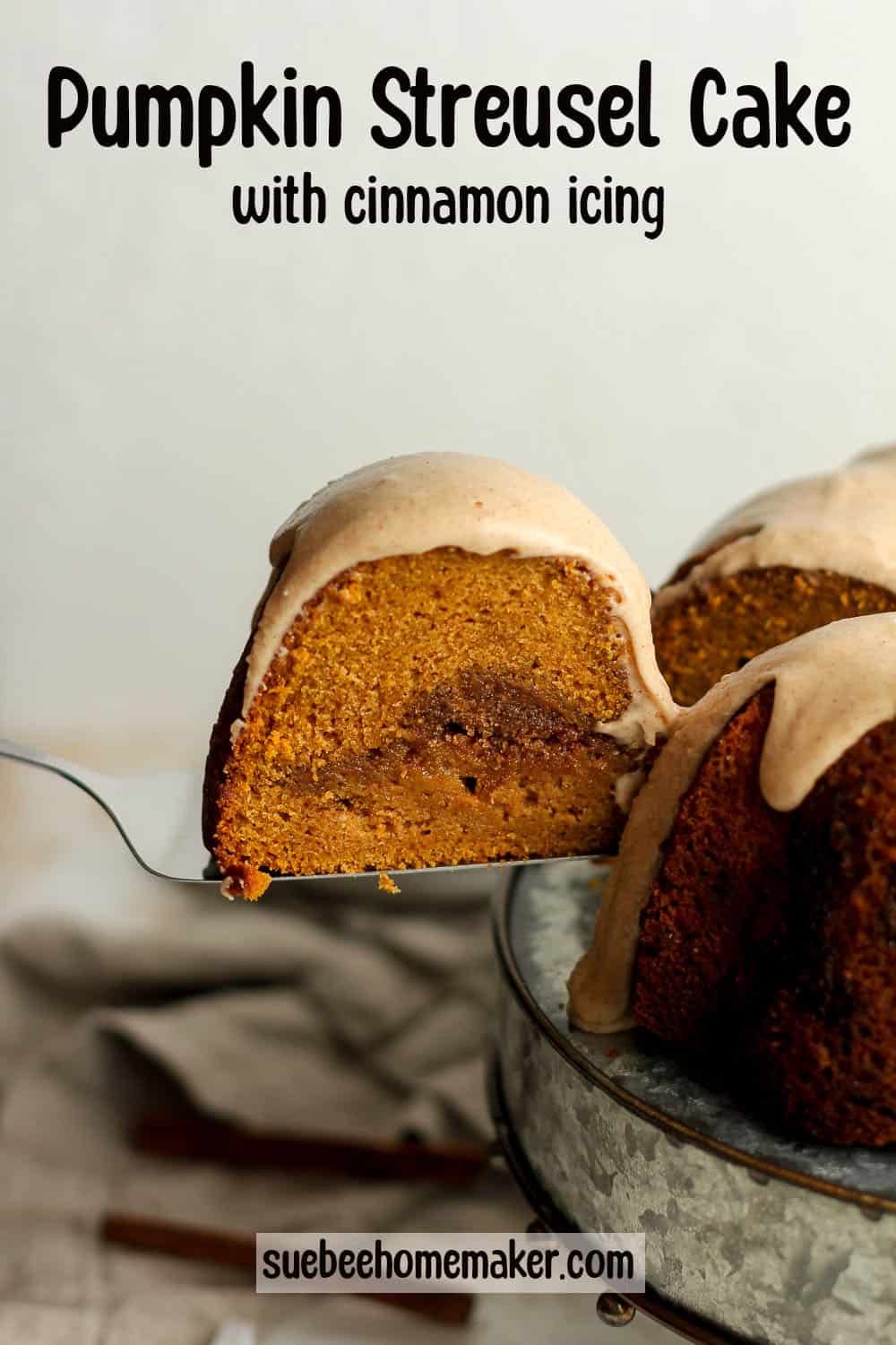 A slice of pumpkin cake being lifted from a whole bundt cake.
