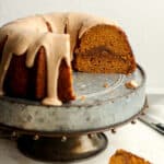 Side view of a partial pumpkin spice bundt cake showing the streusel layer.