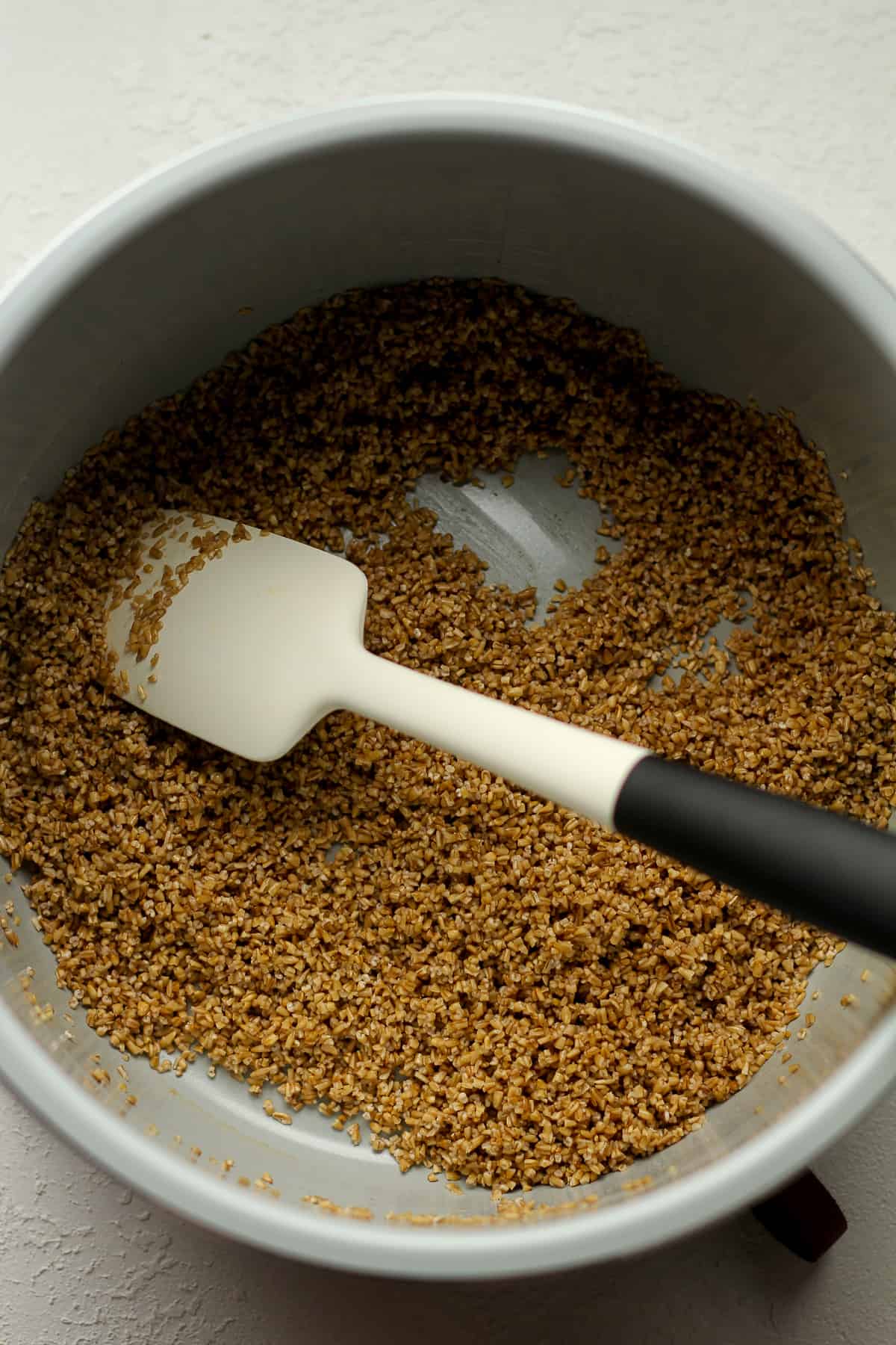 An instant pot of sautéed steel cut oats.