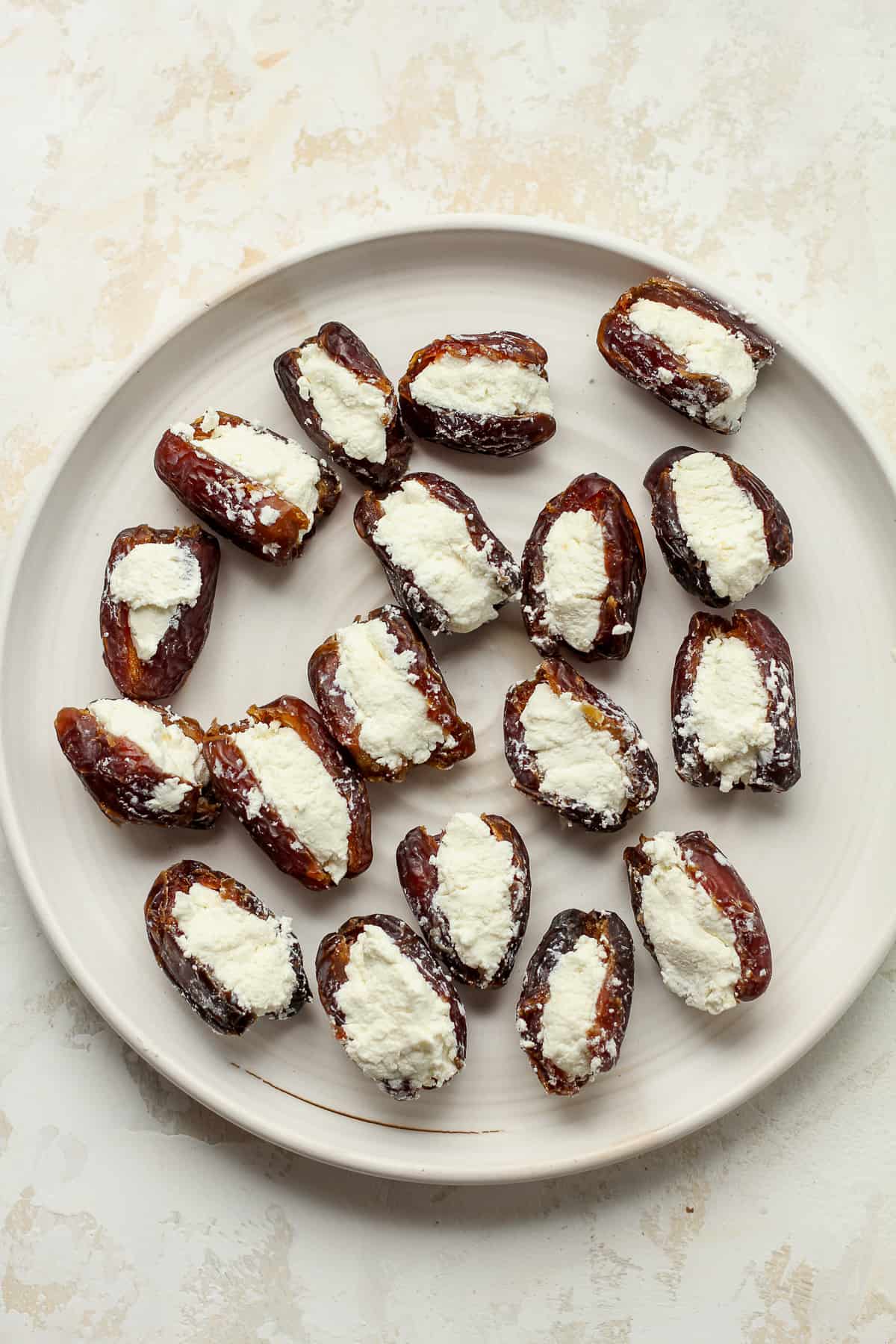 A plate of pitted dates stuffed with goat cheese.