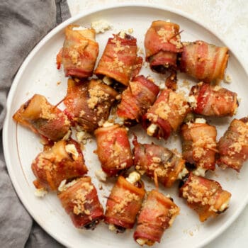 A plate of bacon wrapped dates with goat cheese.
