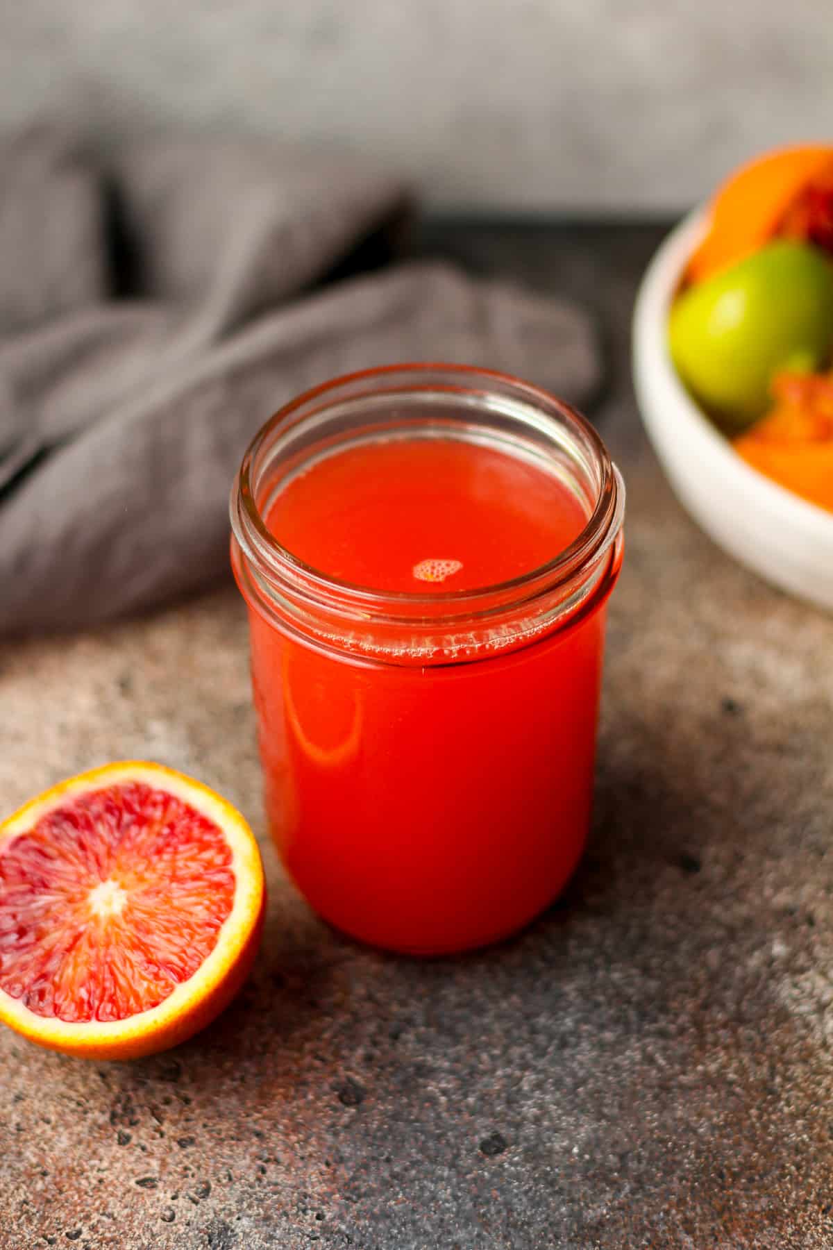 Overhead view of a jar of blood orange margarita mix.