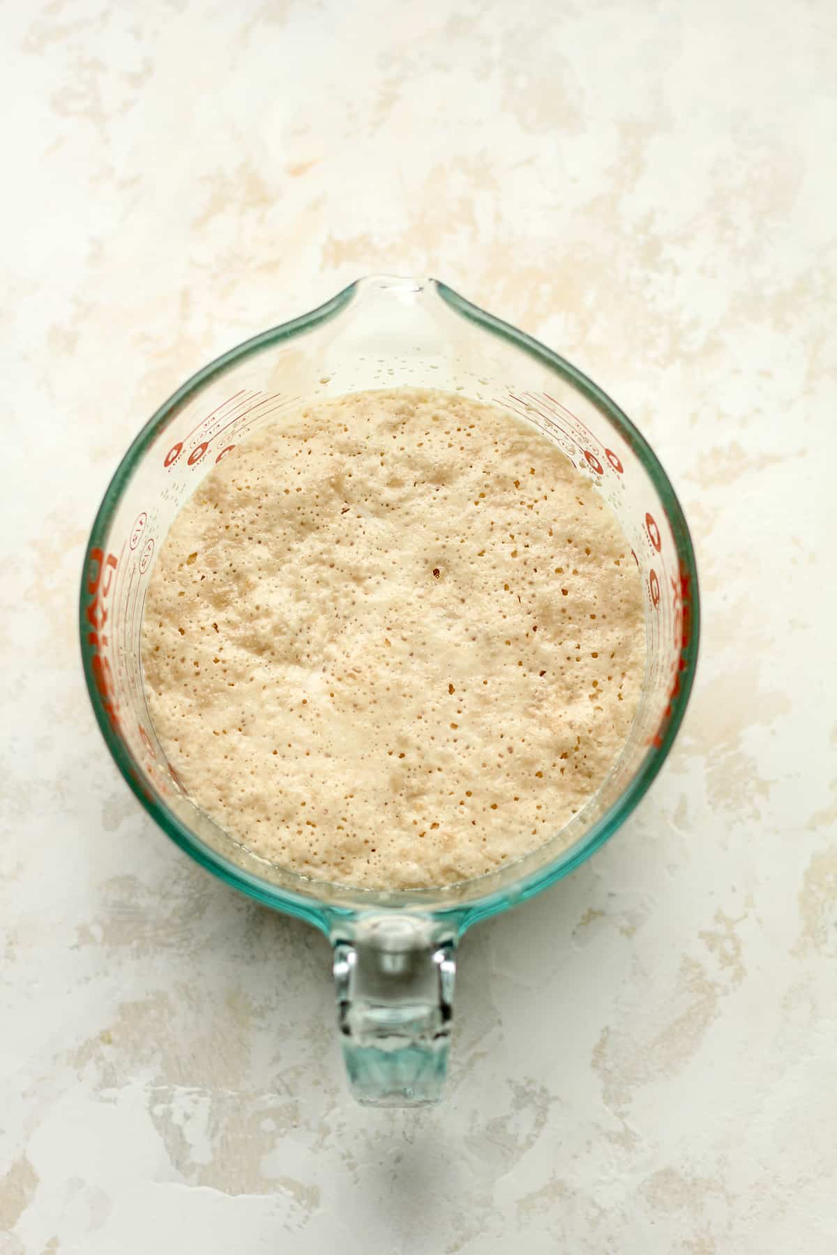 The yeast mixture in a large measuring cup.