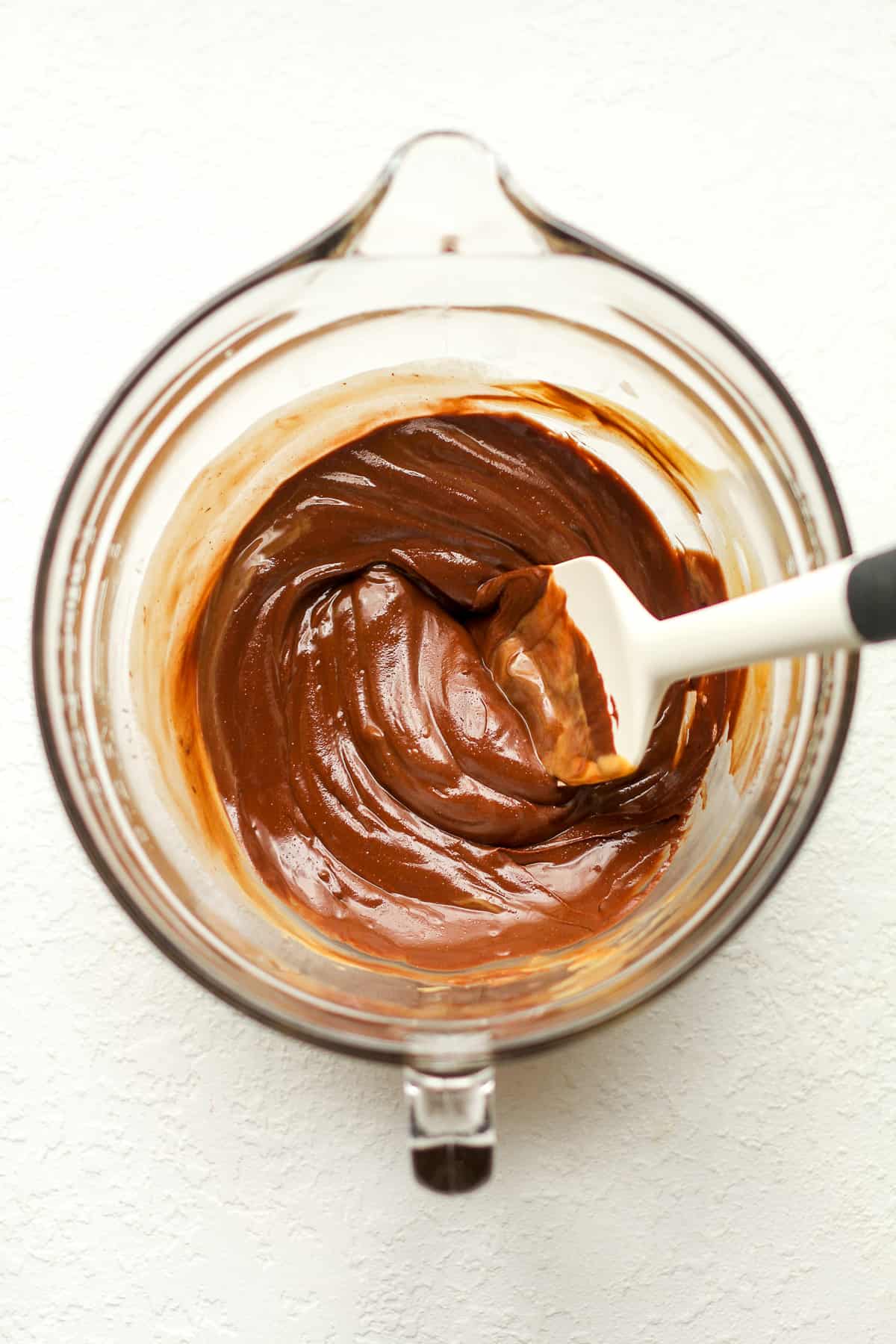 A bowl of the chocolate mixture melted with a spatula.