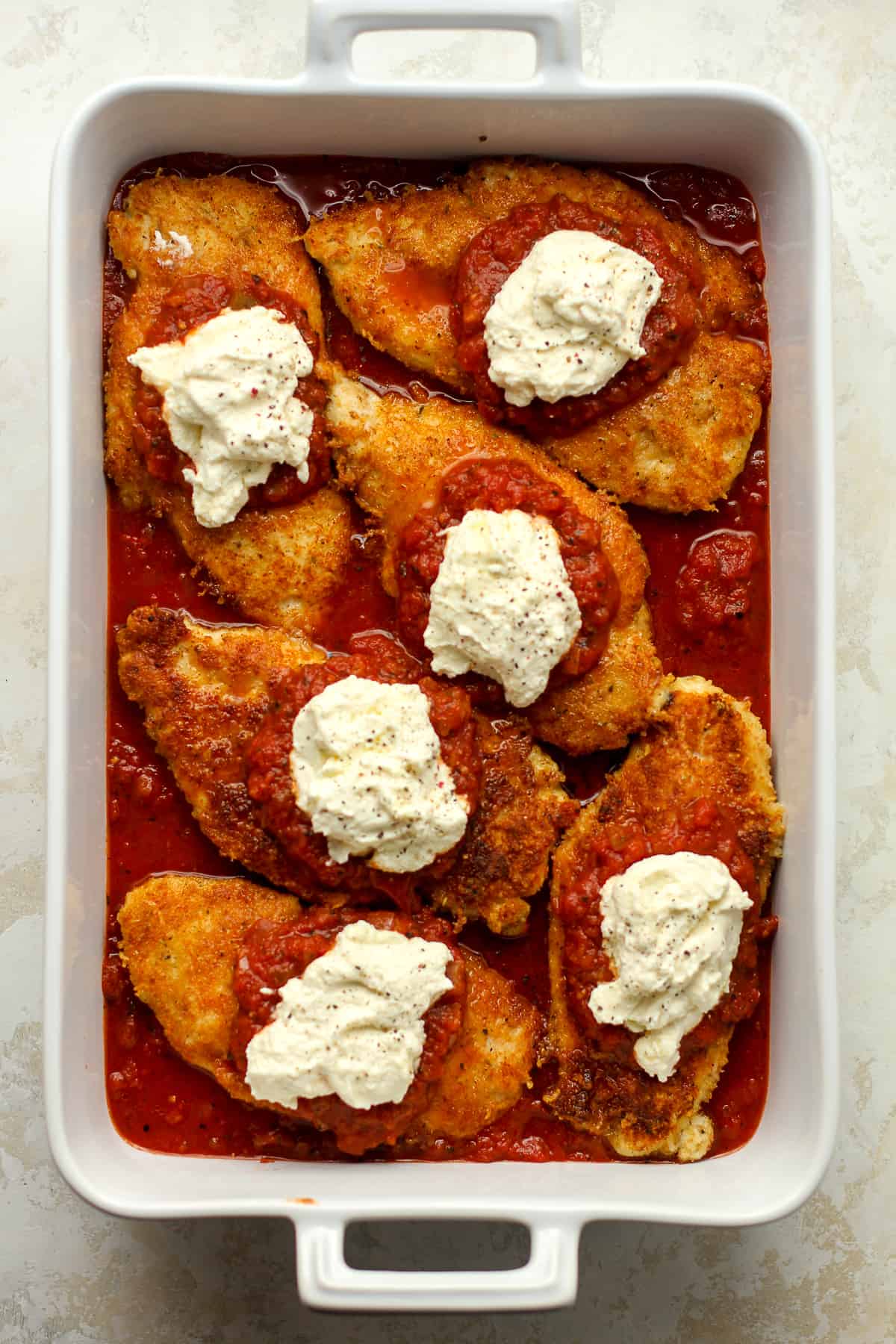 A casserole of chicken parm before finishing in the oven.