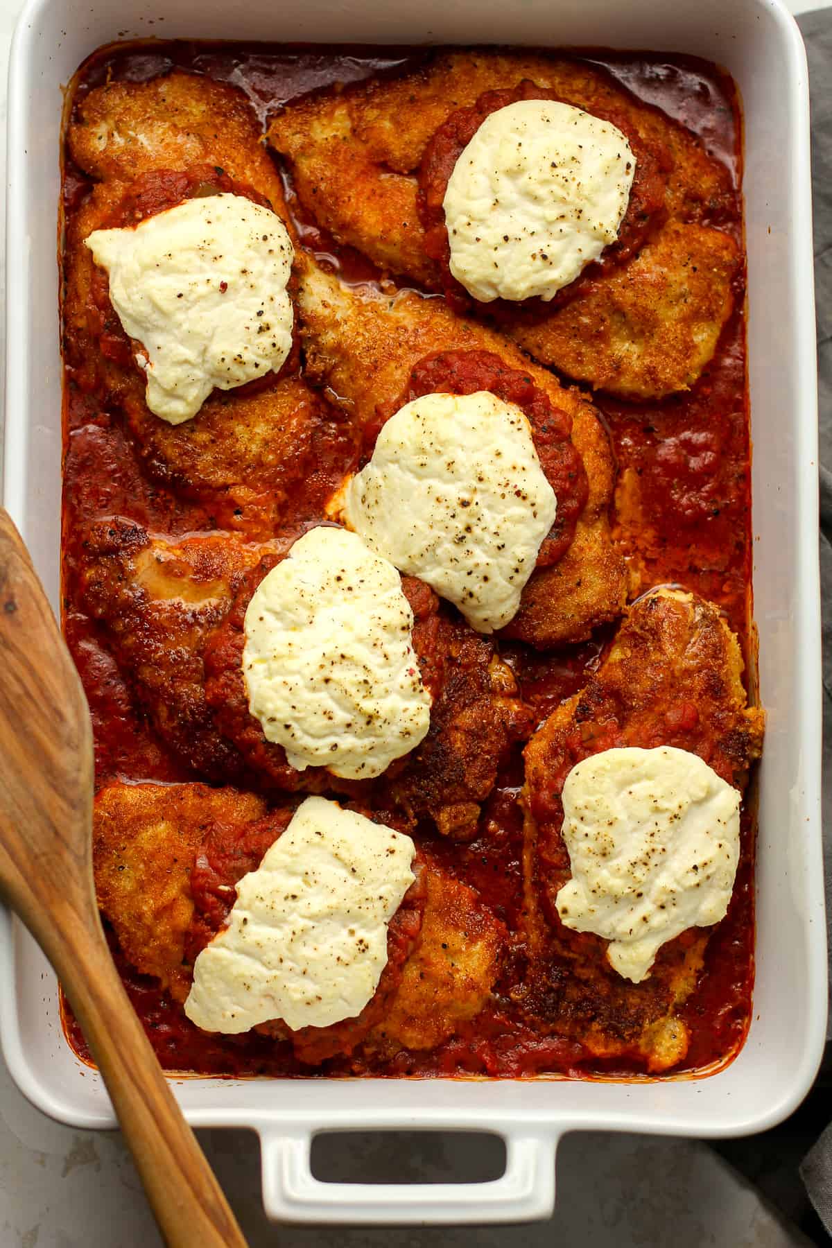 Overhead view of a large casserole of chicken parmesan.