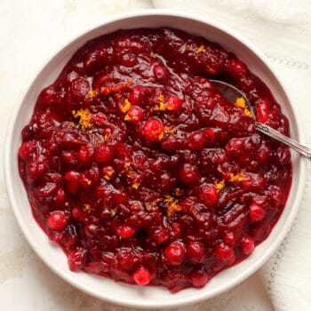 Naturally sweetened cranberry sauce in a bowl with a spoon.