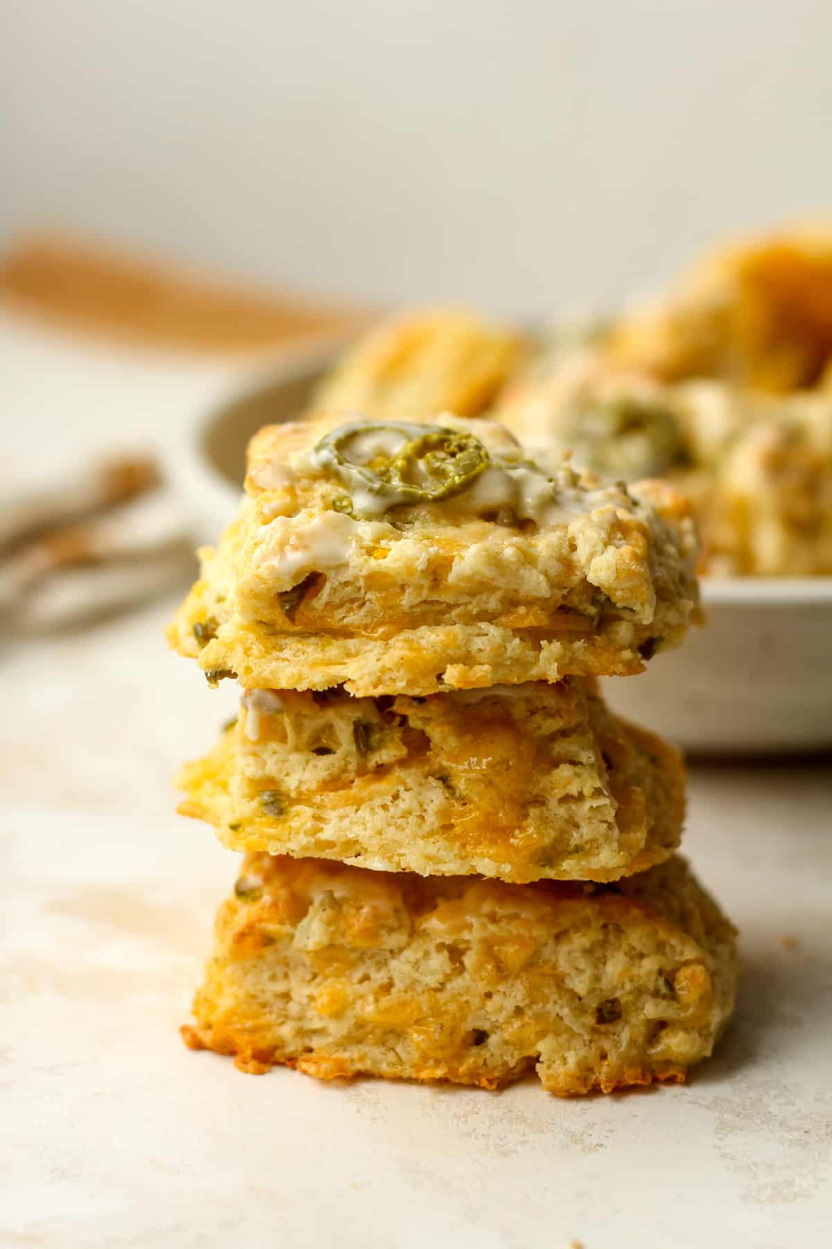 Three flaky jalapeño cheddar biscuits.