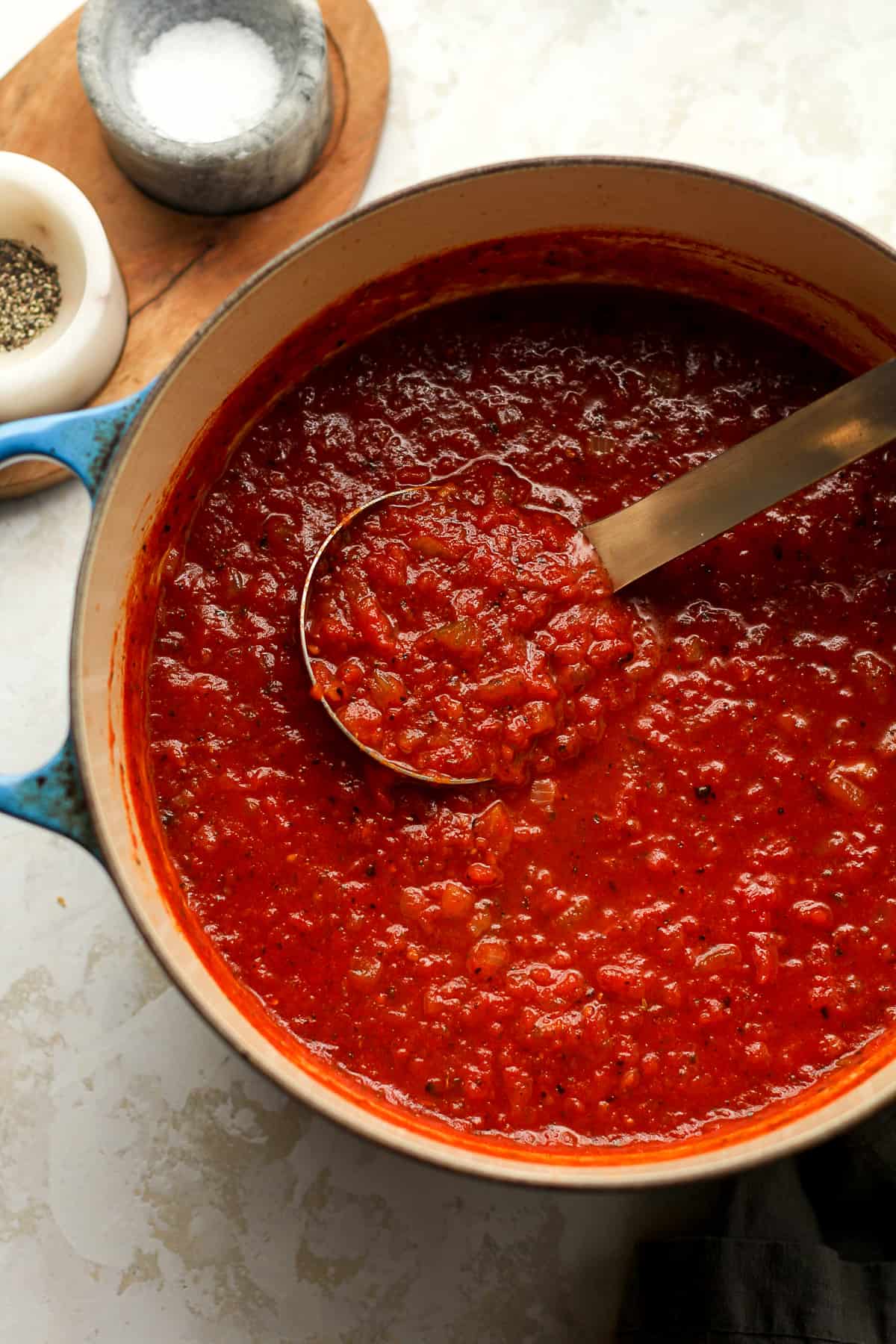 A stock pot of marinara sauce.