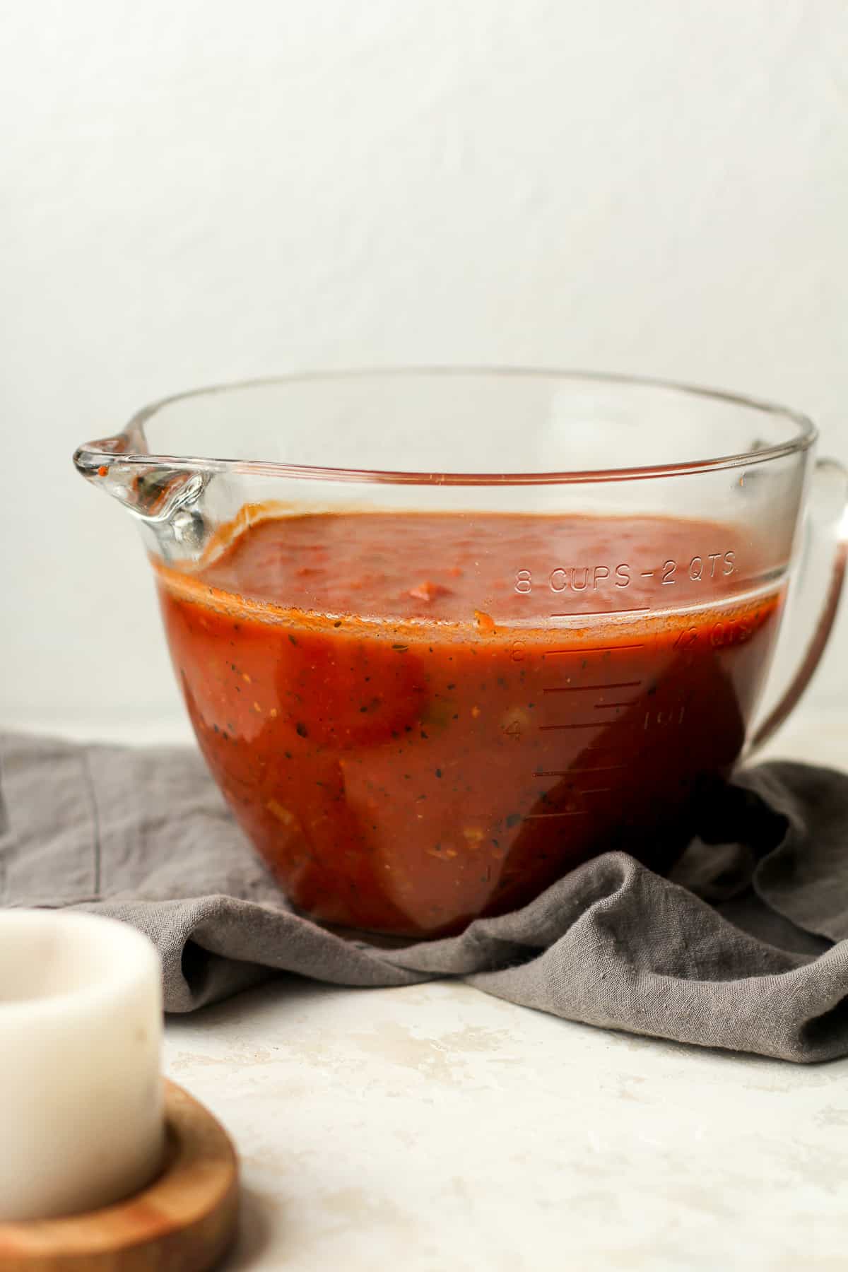 A large measuring cup of homemade sauce.