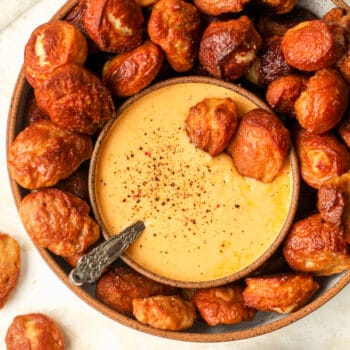 A bowl of homemade pretzel bites with a bowl of cheese dip.