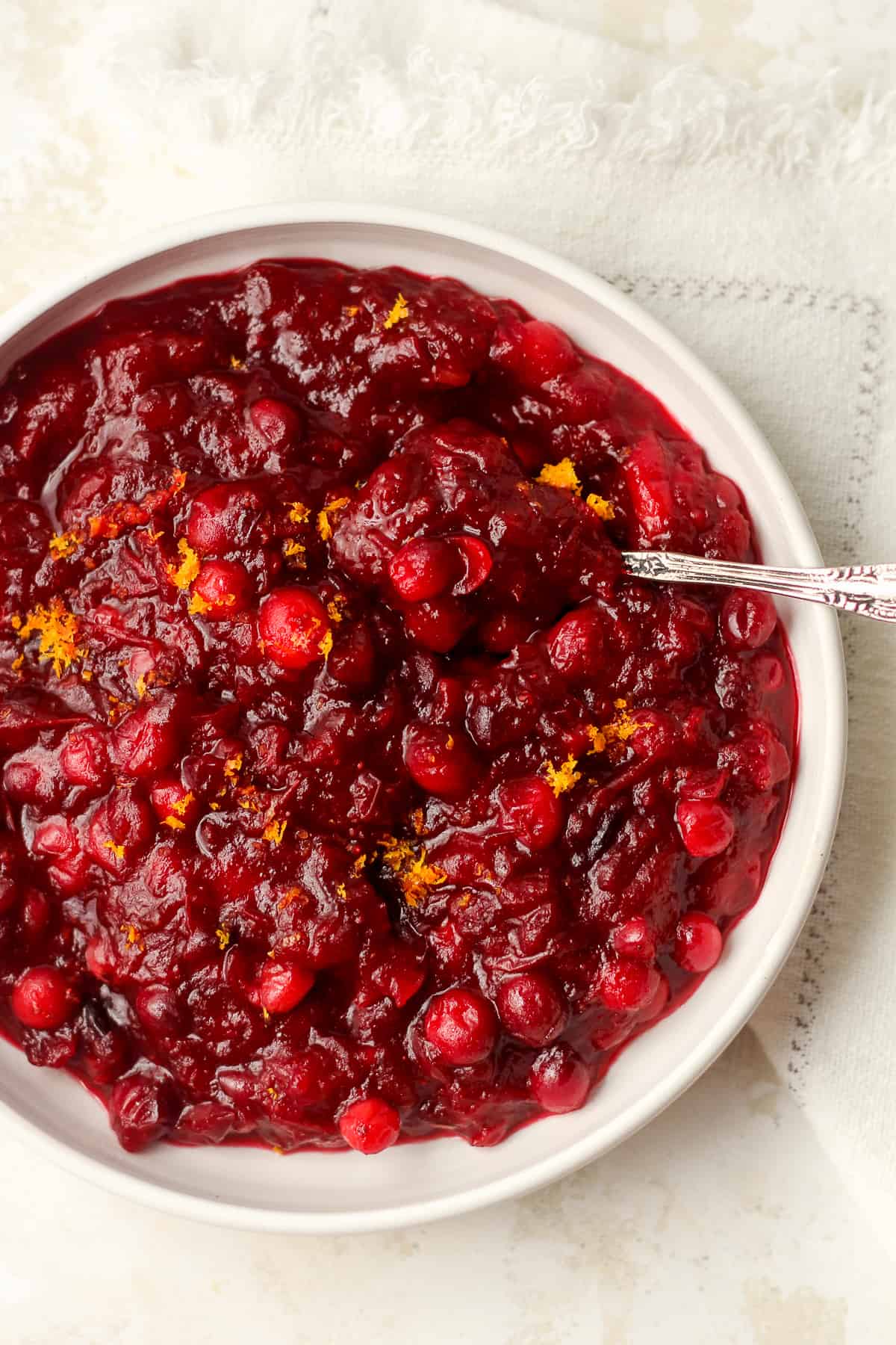 Closeup on some cranberry sauce with a spoon.