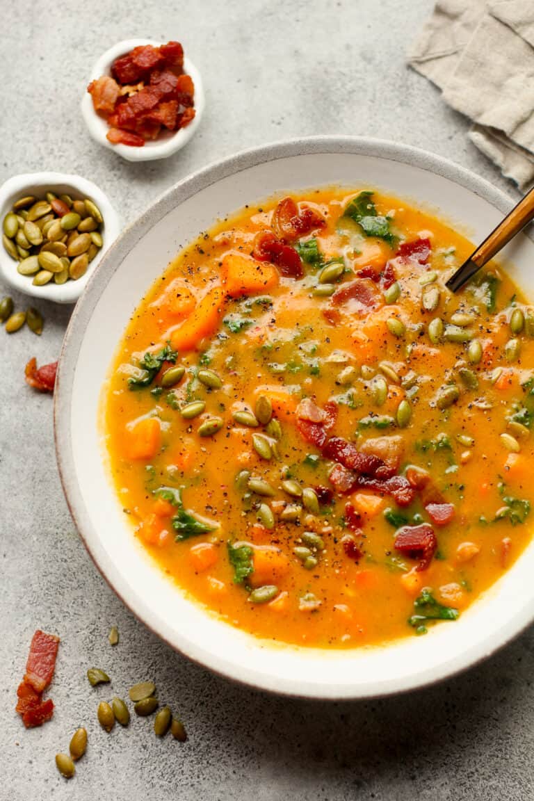 A closeup shot on a shallow bowl of sweet potato soup.