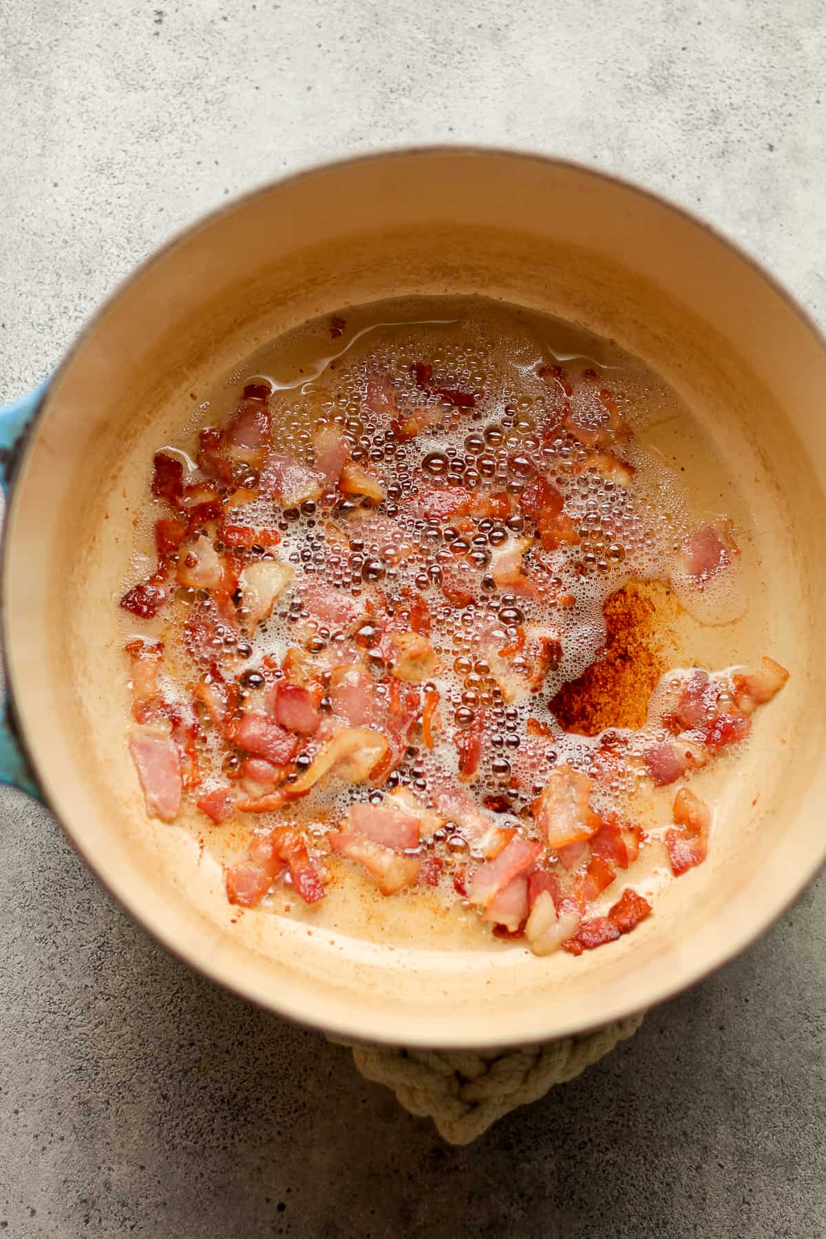 A pot of the fried bacon bits.