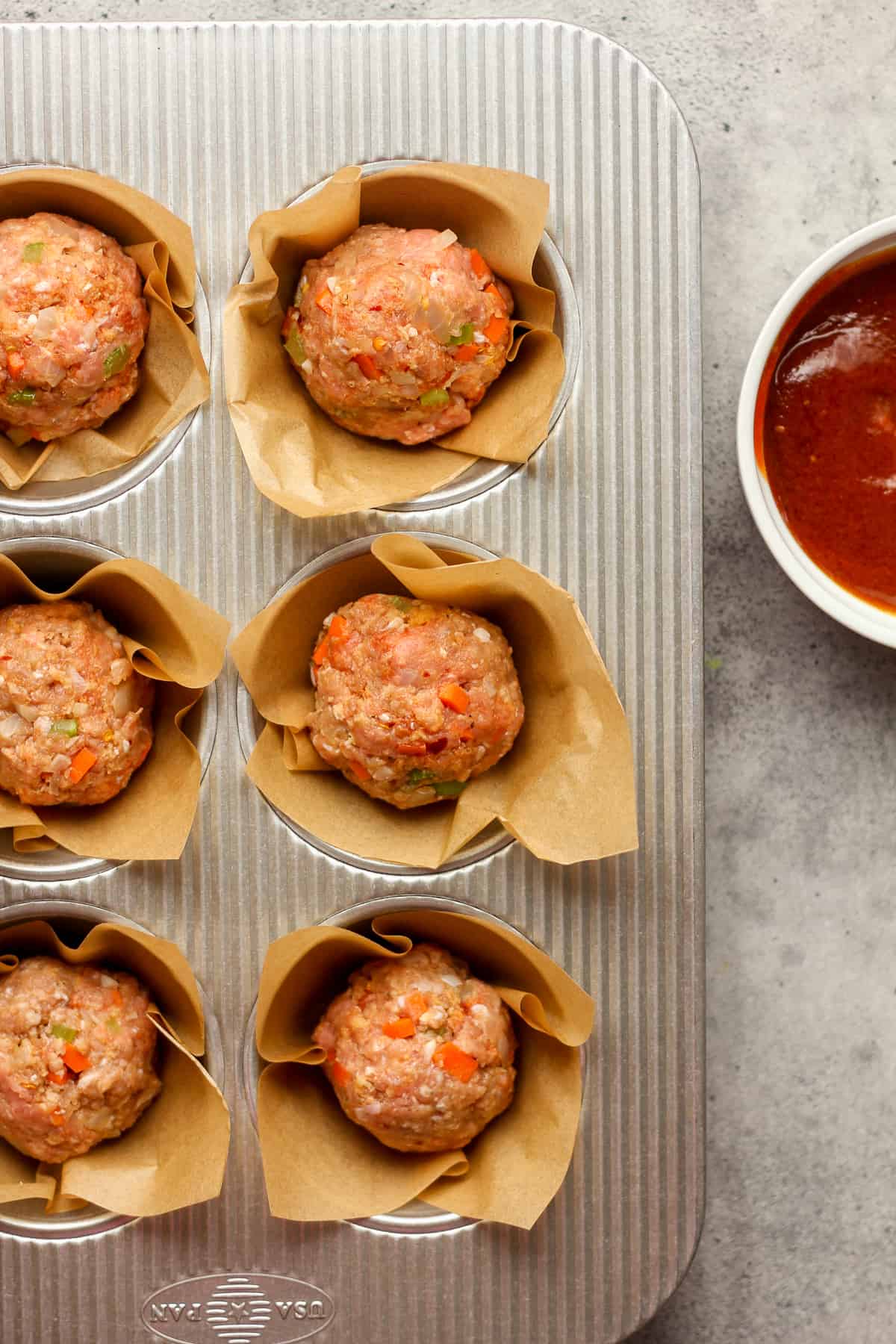 The raw turkey meatloaf in muffin tins.