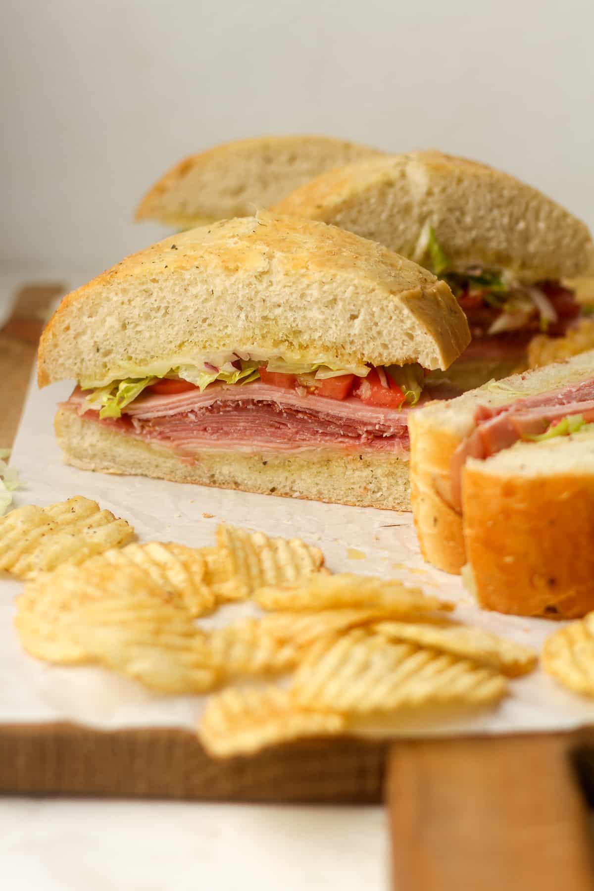 Side view of some sliced Italian sub sandwiches.