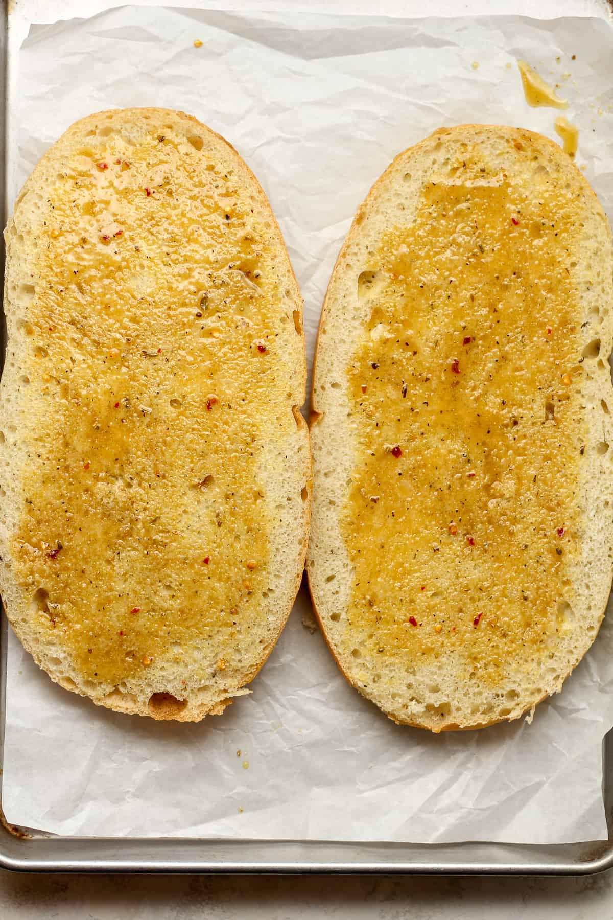 The two sides of the bread with Italian dressing brushed on top.