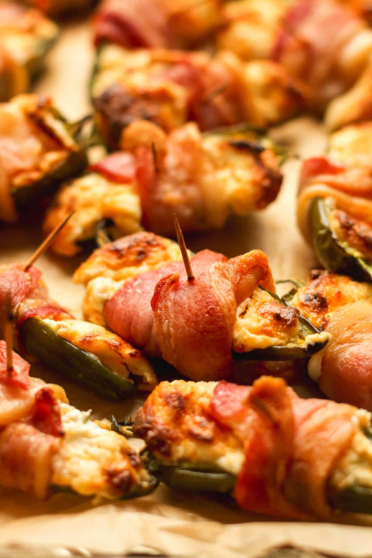 Side view of some bacon wrapped jalapeño poppers.