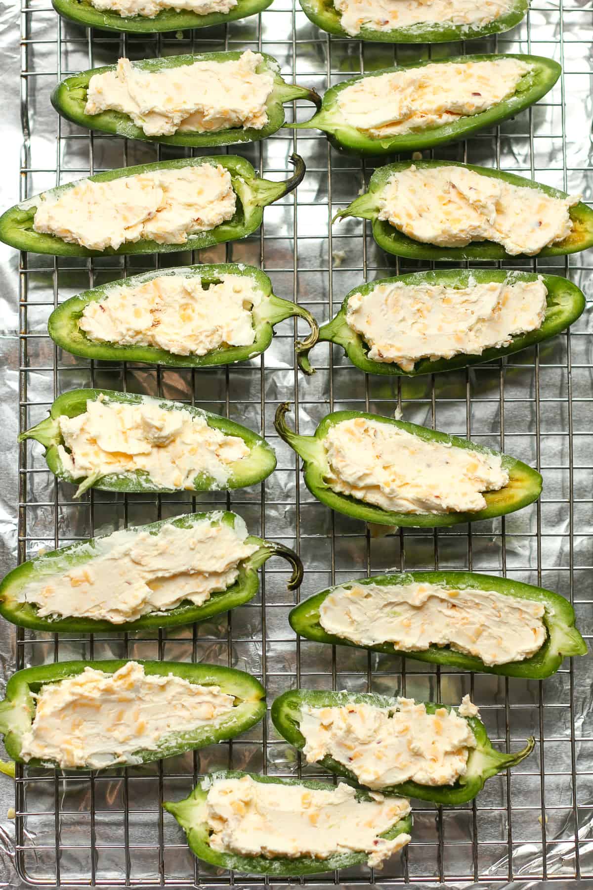 Halved jalapeno peppers stuffed with cream cheese and cheddar cheese.
