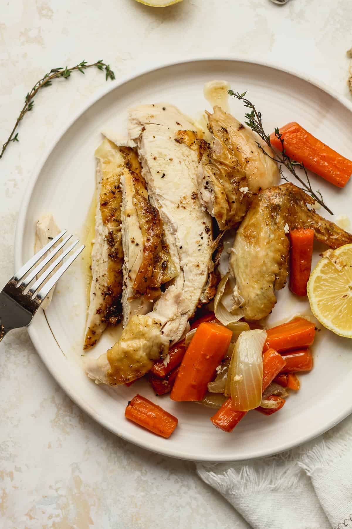 A plate of sliced chicken and carrots.