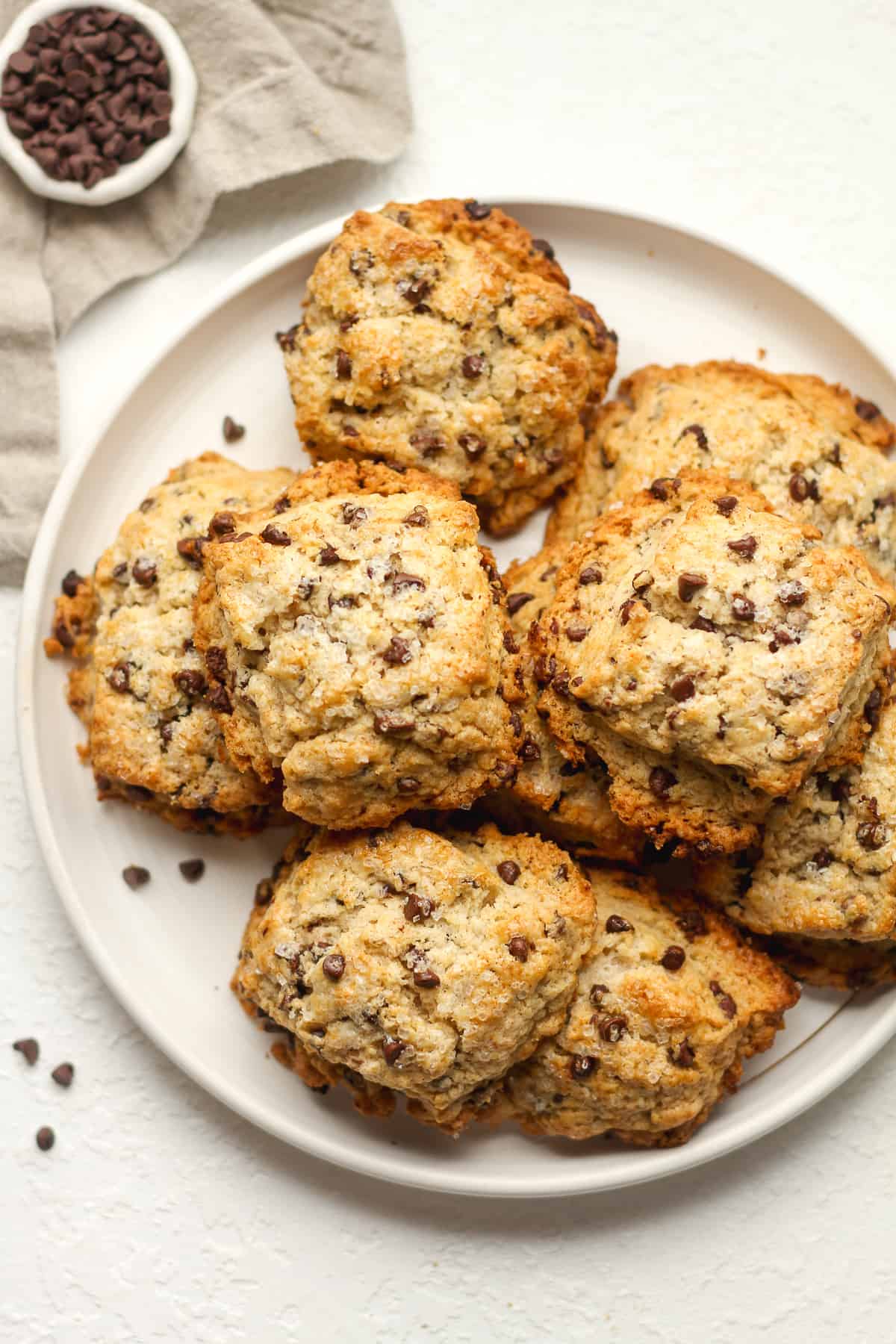 A plate of stacked scones with mini chocolate chips.