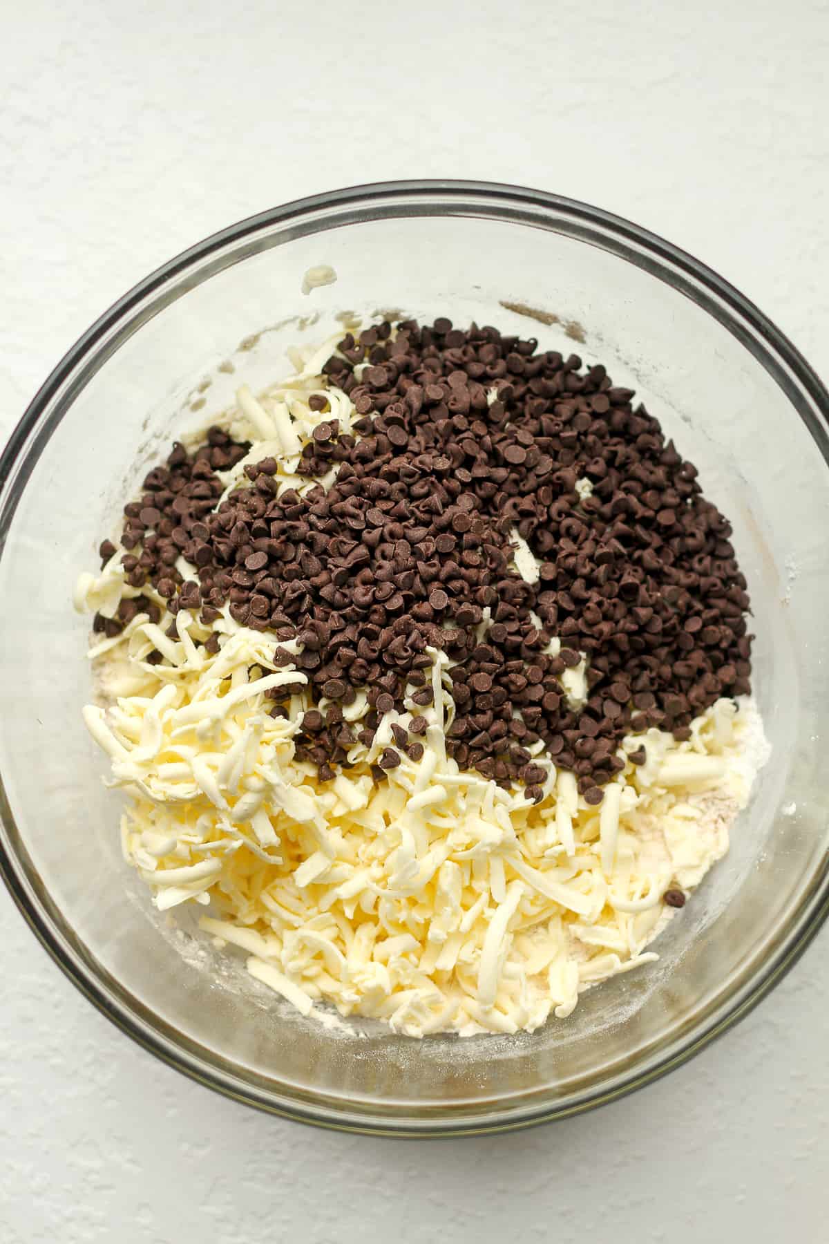 The dry ingredients with the shredded butter and mini chocolate chips on top.