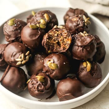 Side closeup view of the date nut balls with chocolate coating.