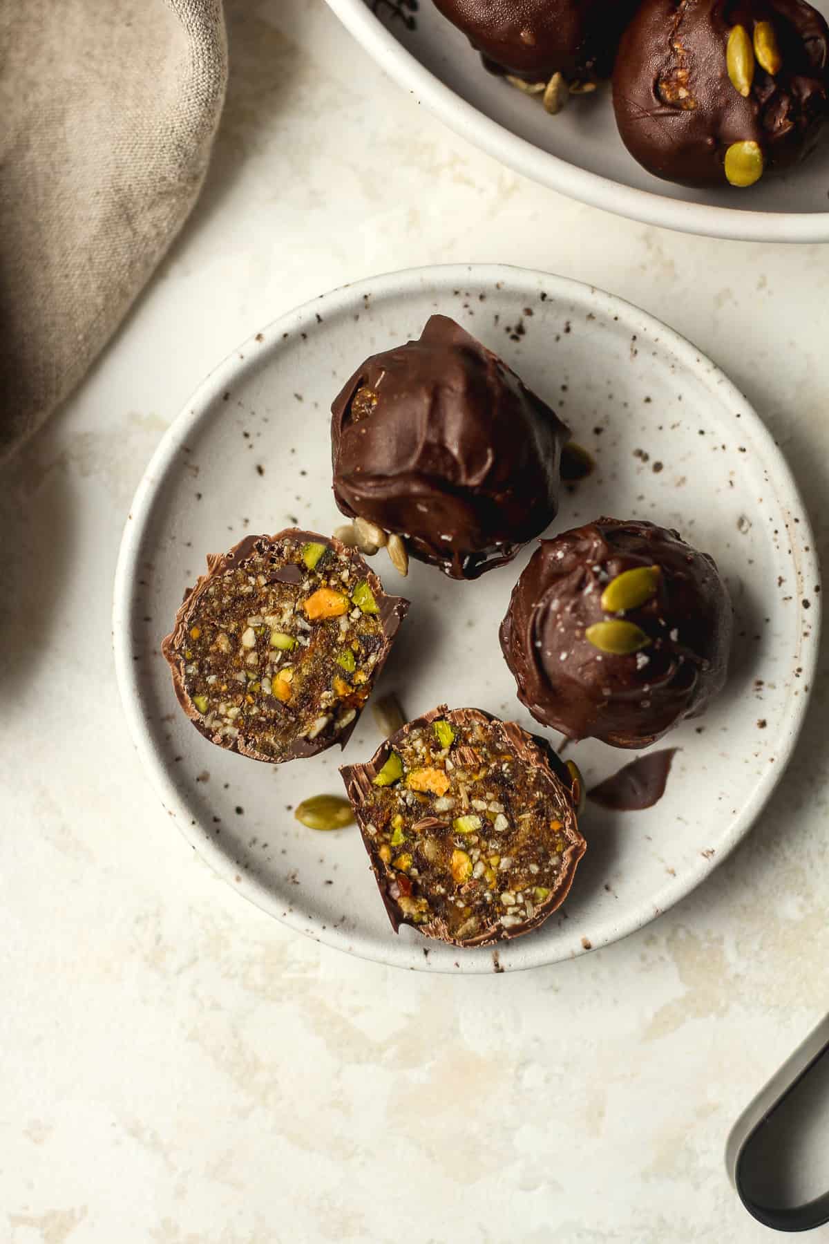 A small plate of date nut balls, one split in half.