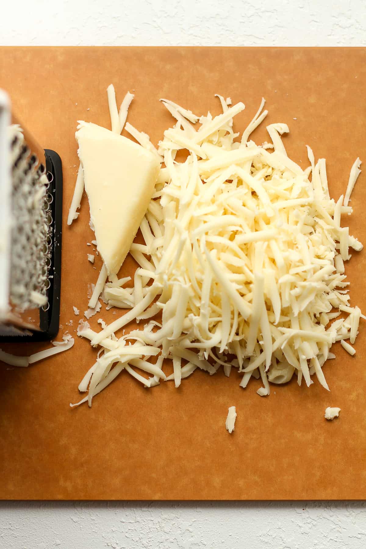 A board of the shredded quiche cheese.
