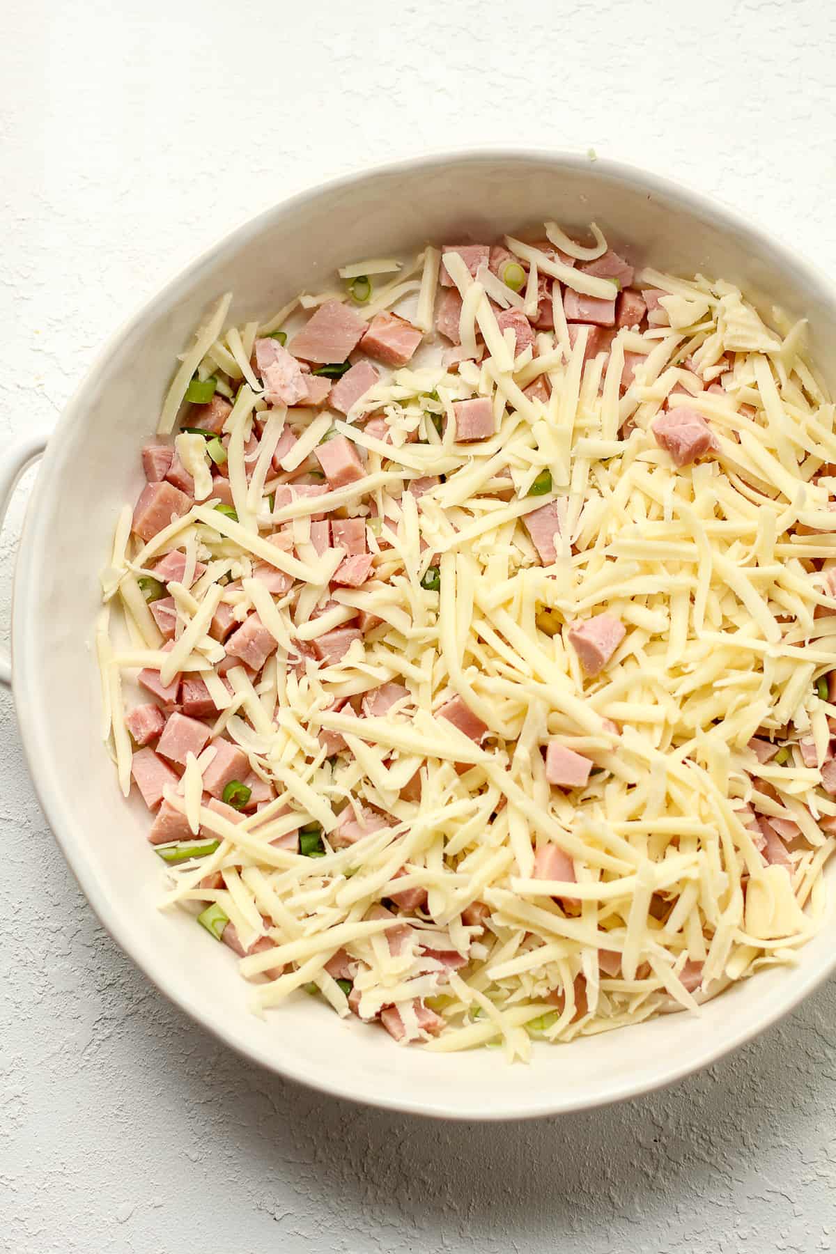 The dish with the ham, green onions, and gruyere cheese.
