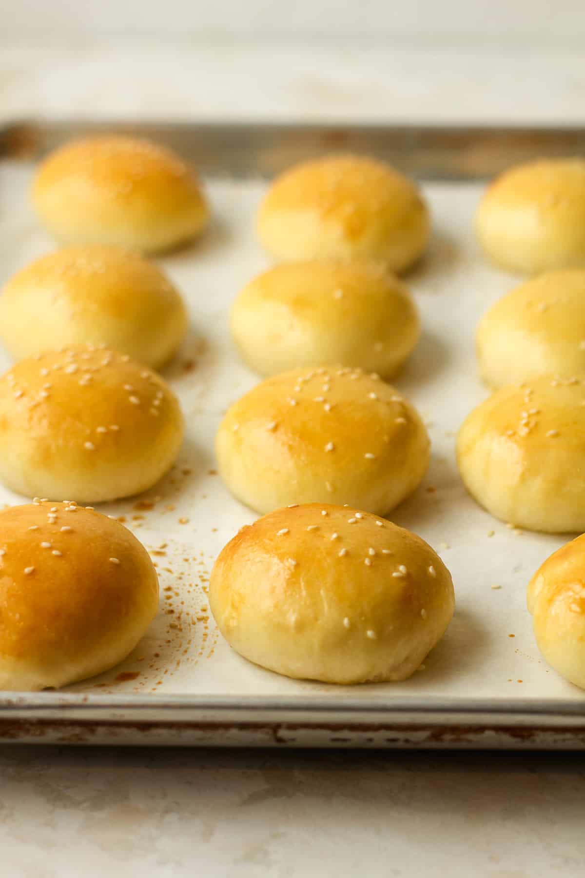 Side view of a pan of baked slider buns.