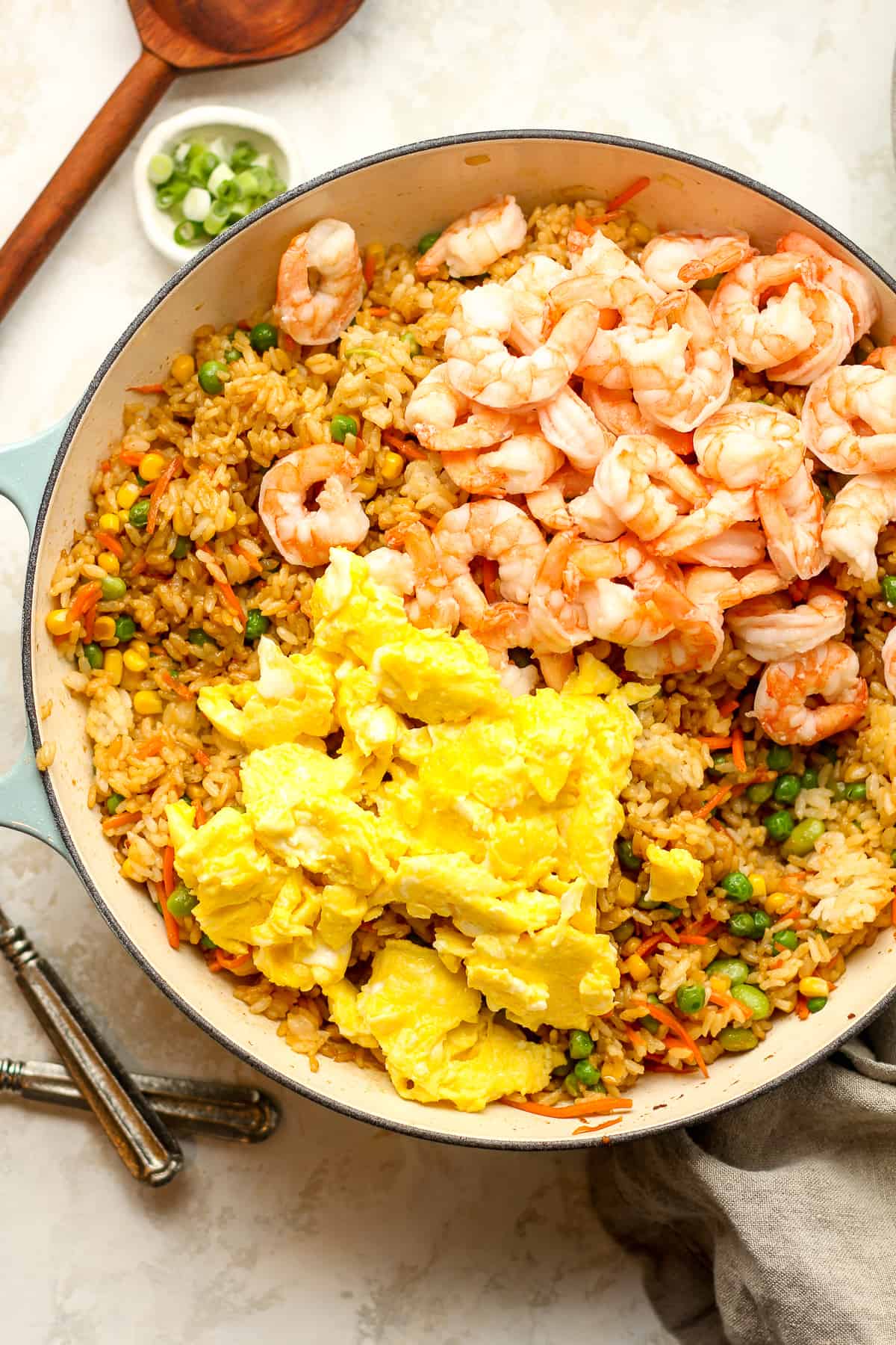 The pot of fried rice with shrimp and soft eggs on top.