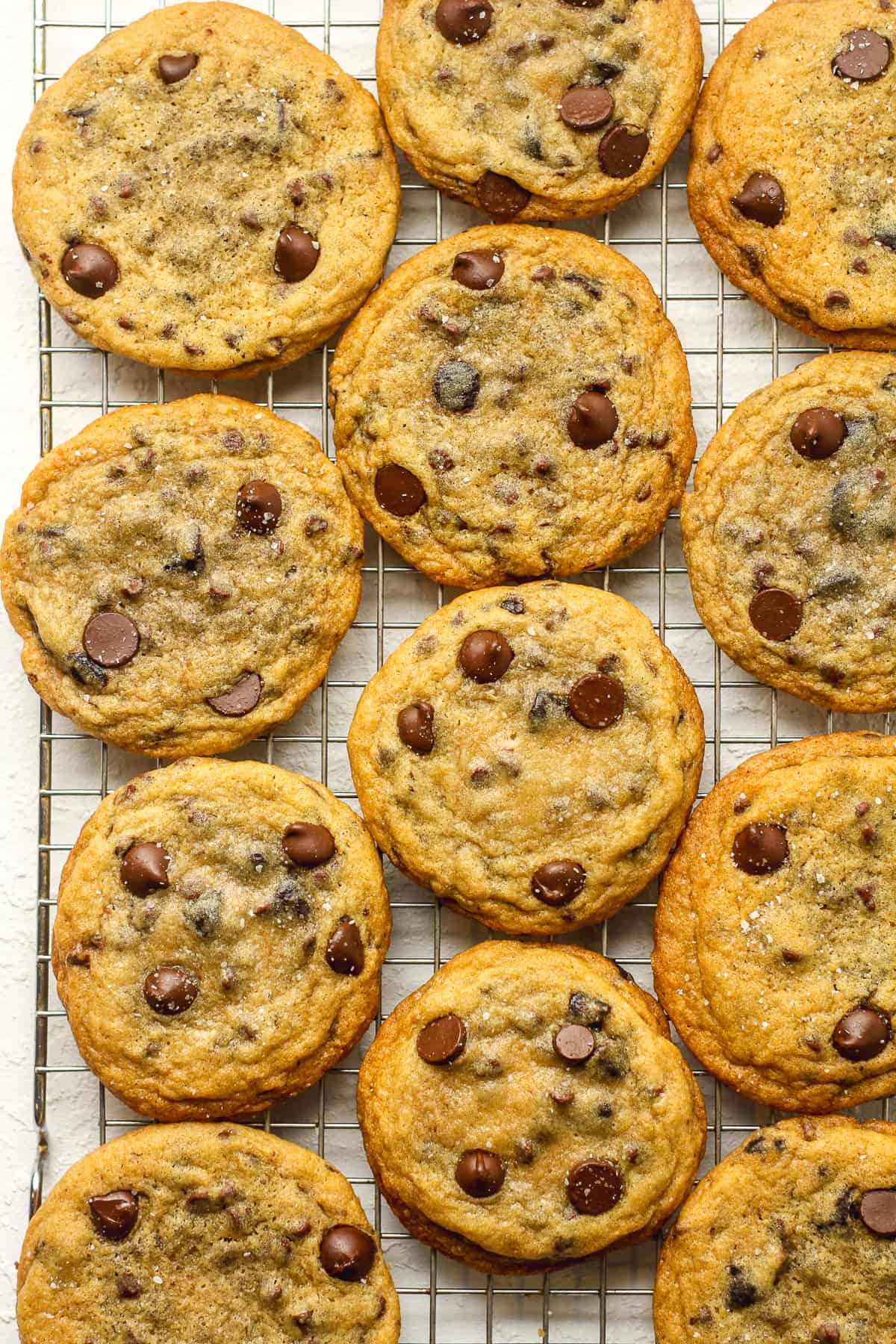 A wire rack of chocolate chip cookies.