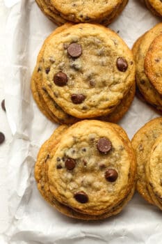 Closeup on some stacked chocolate chip cookies.
