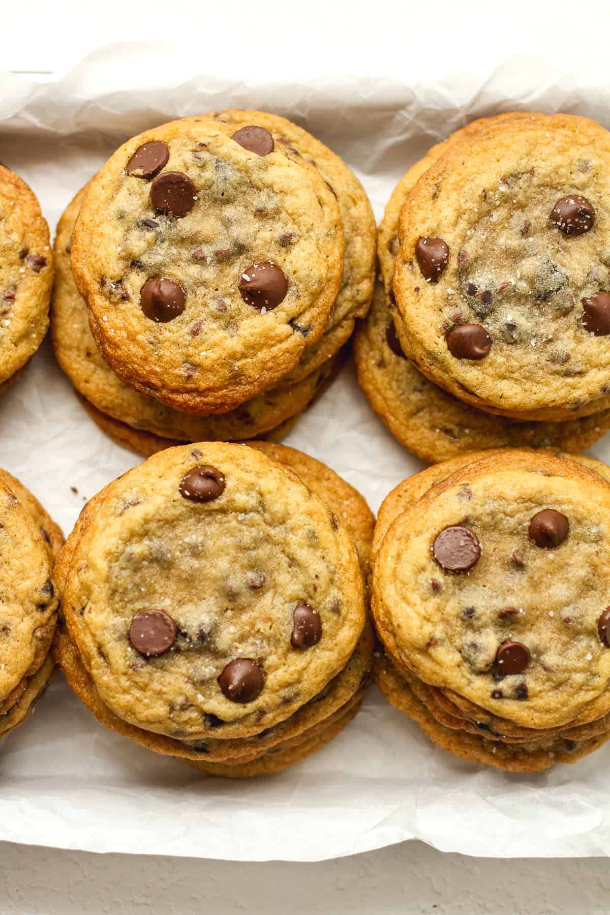 Overhead view of some stacked super soft chocolate chip cookies.
