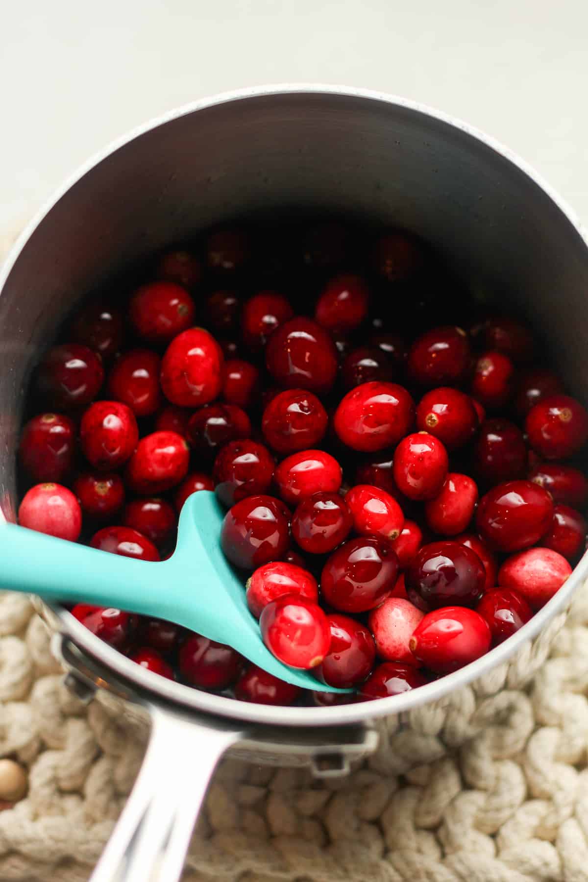 A saucepan of the cranberries in simple syrup.