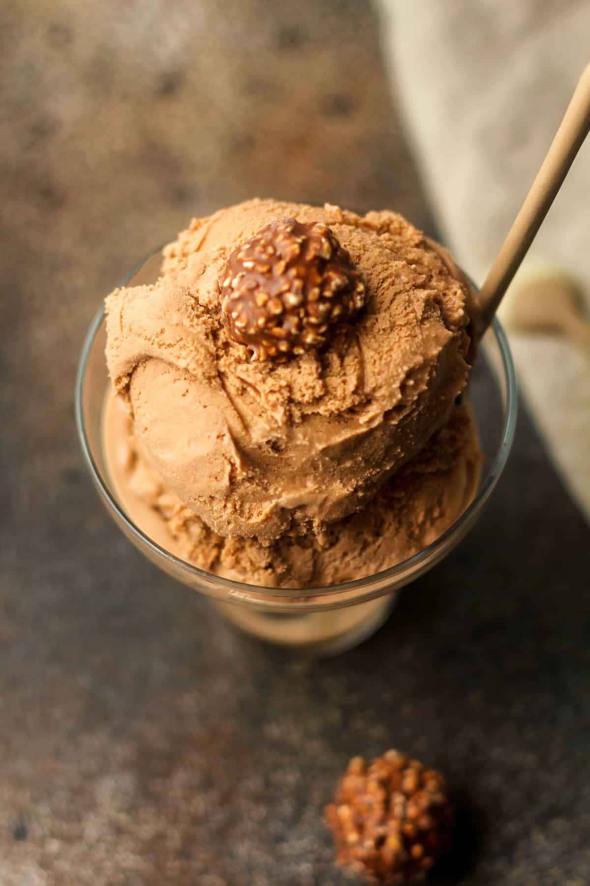 Overhead view of a bowl of nutella ice cream with a Ferrero Rocher candy on top.