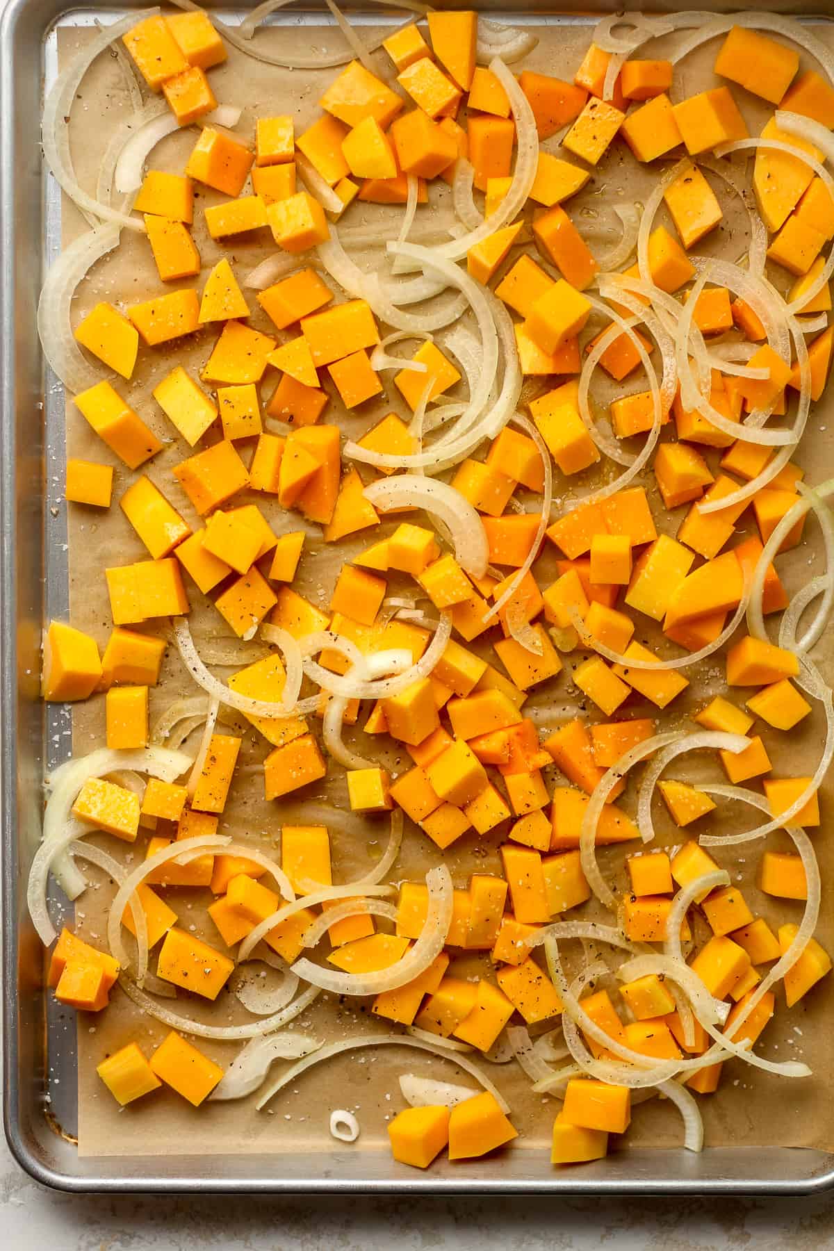 A pan of the cubed butternut squash and sliced onion.