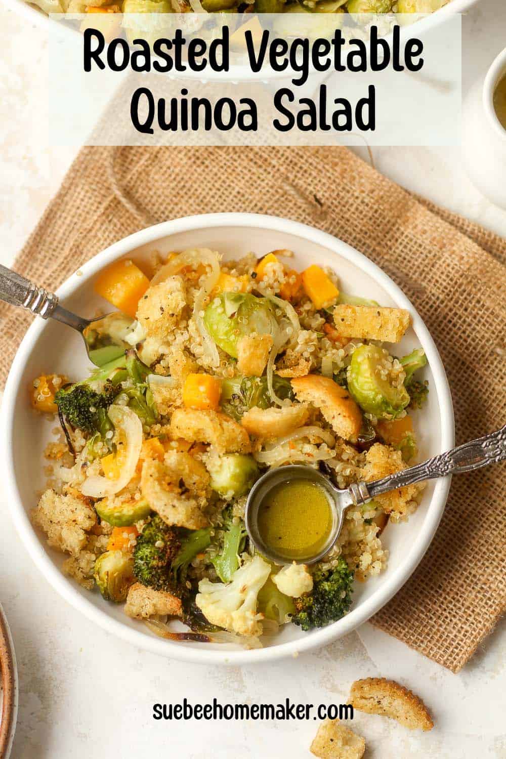 A serving of roasted vegetable quinoa salad with a tablespoon of lemon dressing and homemade croutons.