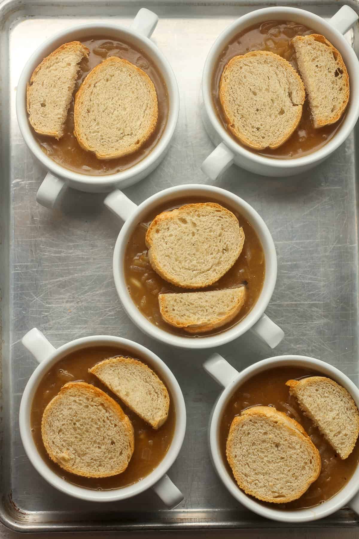 The bowls of soup with the toasted bread on top.