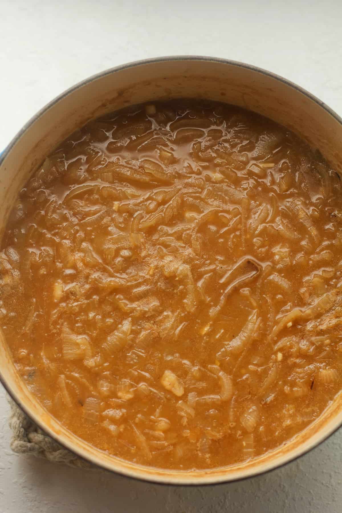 The large pot of French onion soup.