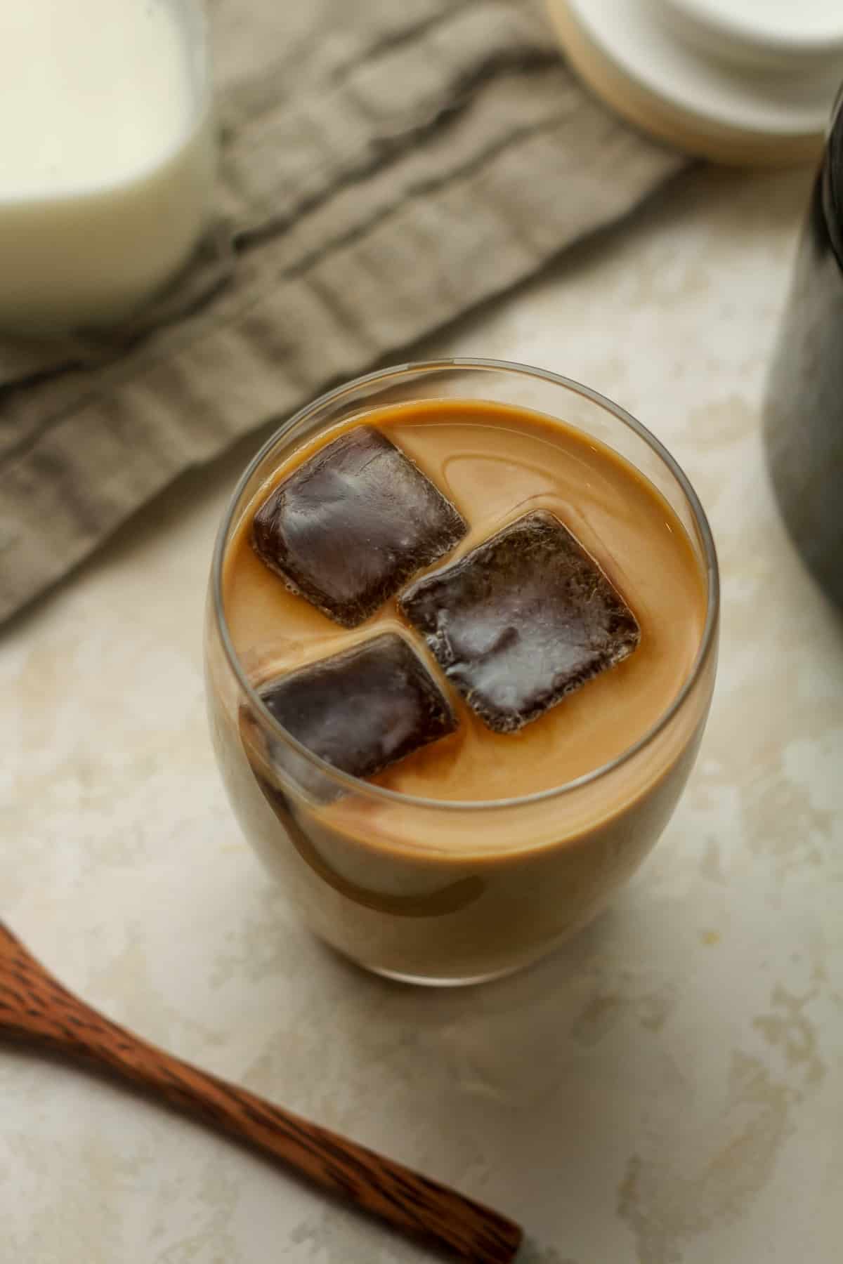 Overhead view of a glass of cold brew coffee with coffee cubes.