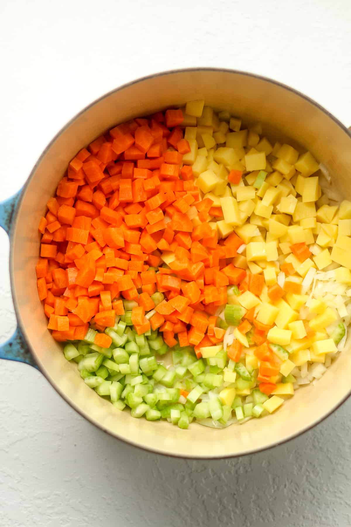 The diced veggies in the stock pot.
