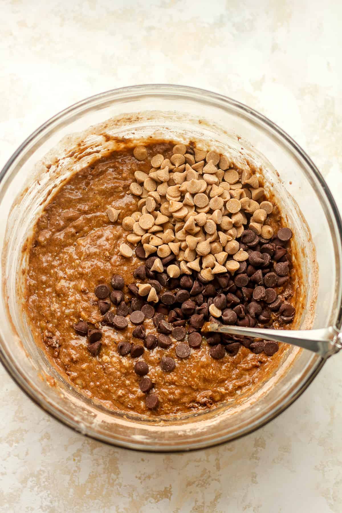 A bowl of the wet ingredients after adding in the peanut butter and chocolate chips.