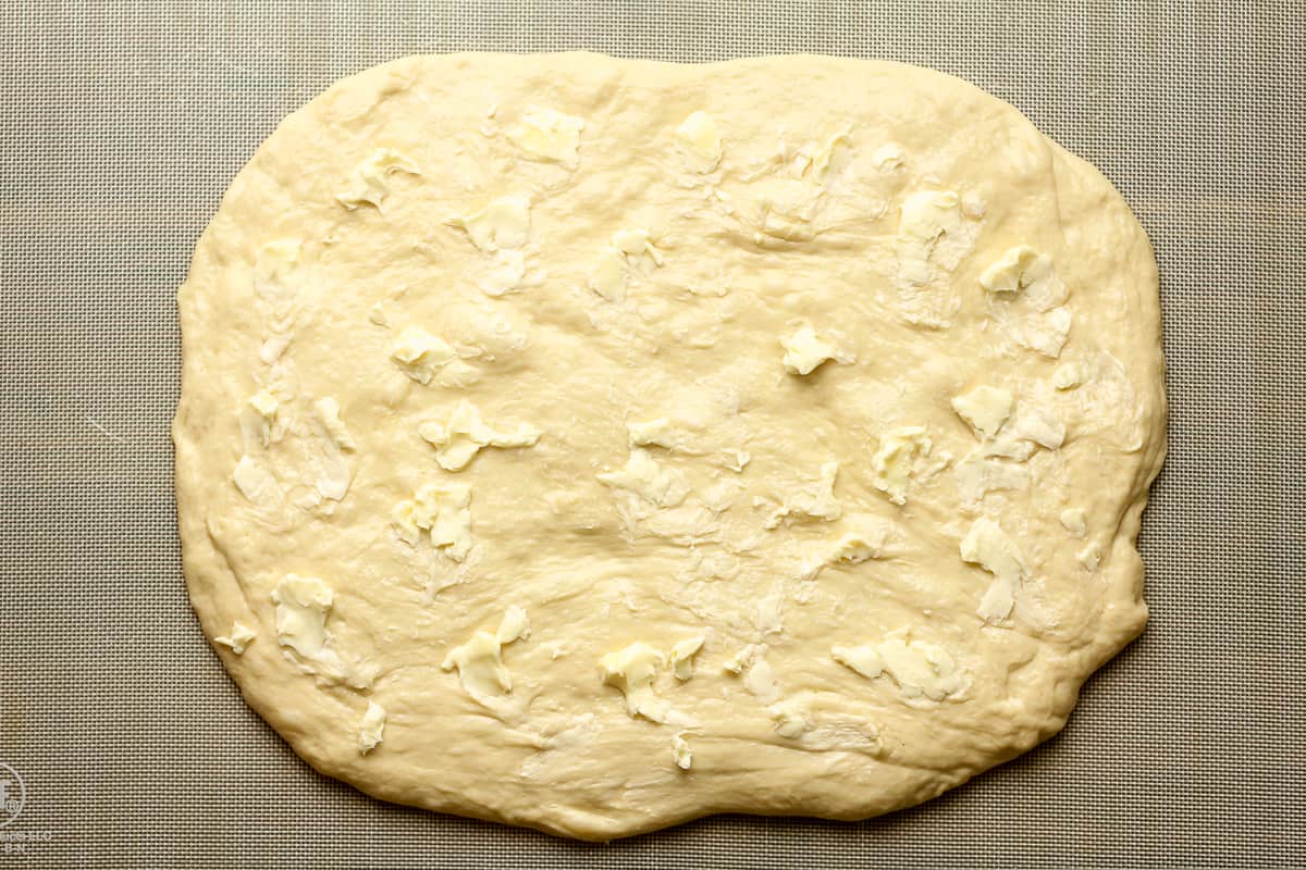 The dough rectangle with butter pats on top.