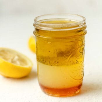 Side view of a jar of honey lemon dressing.